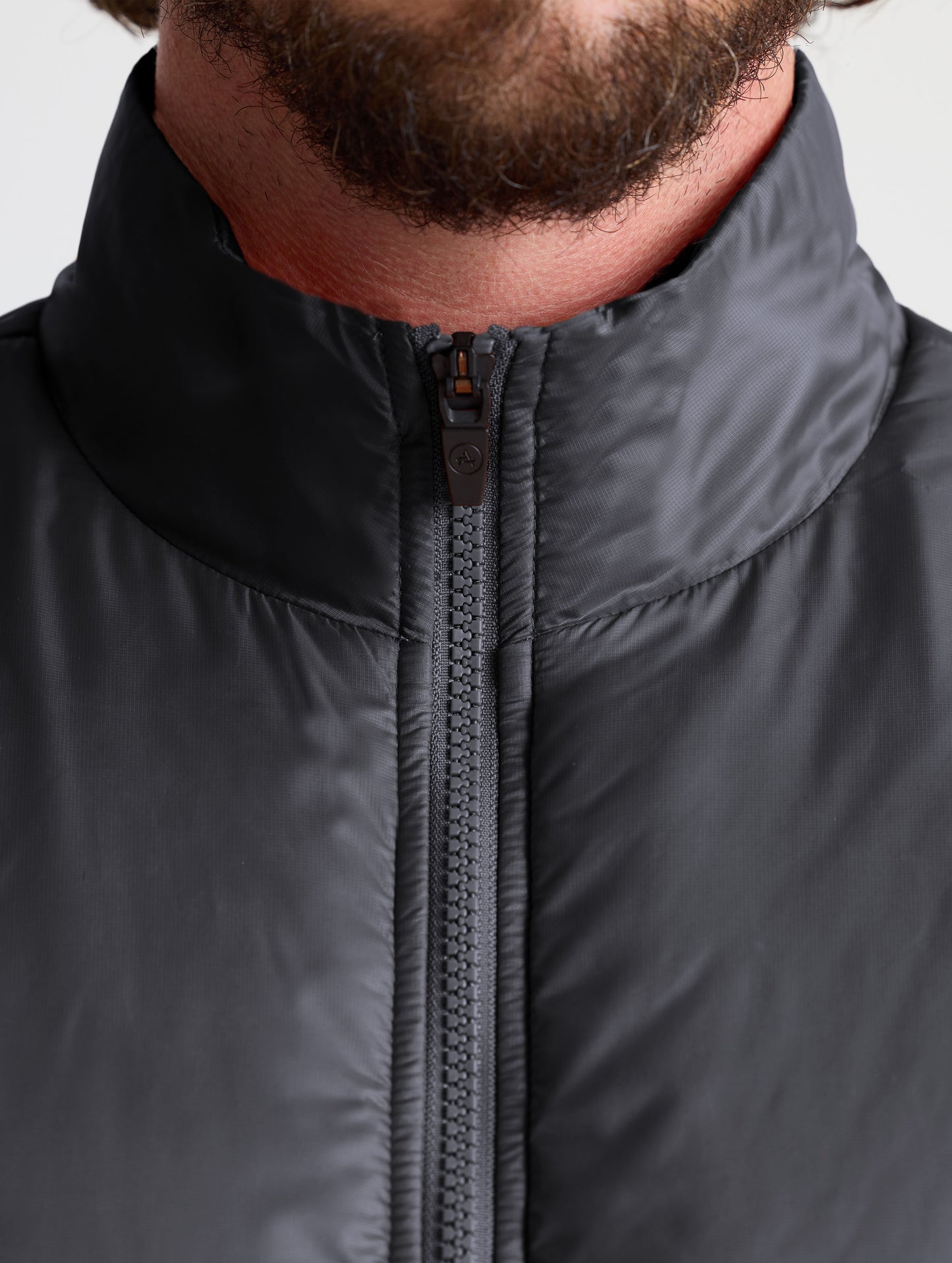 Closeup view of collar of Eco Insulated Jacket in Onyx Black from AETHER Apparel.