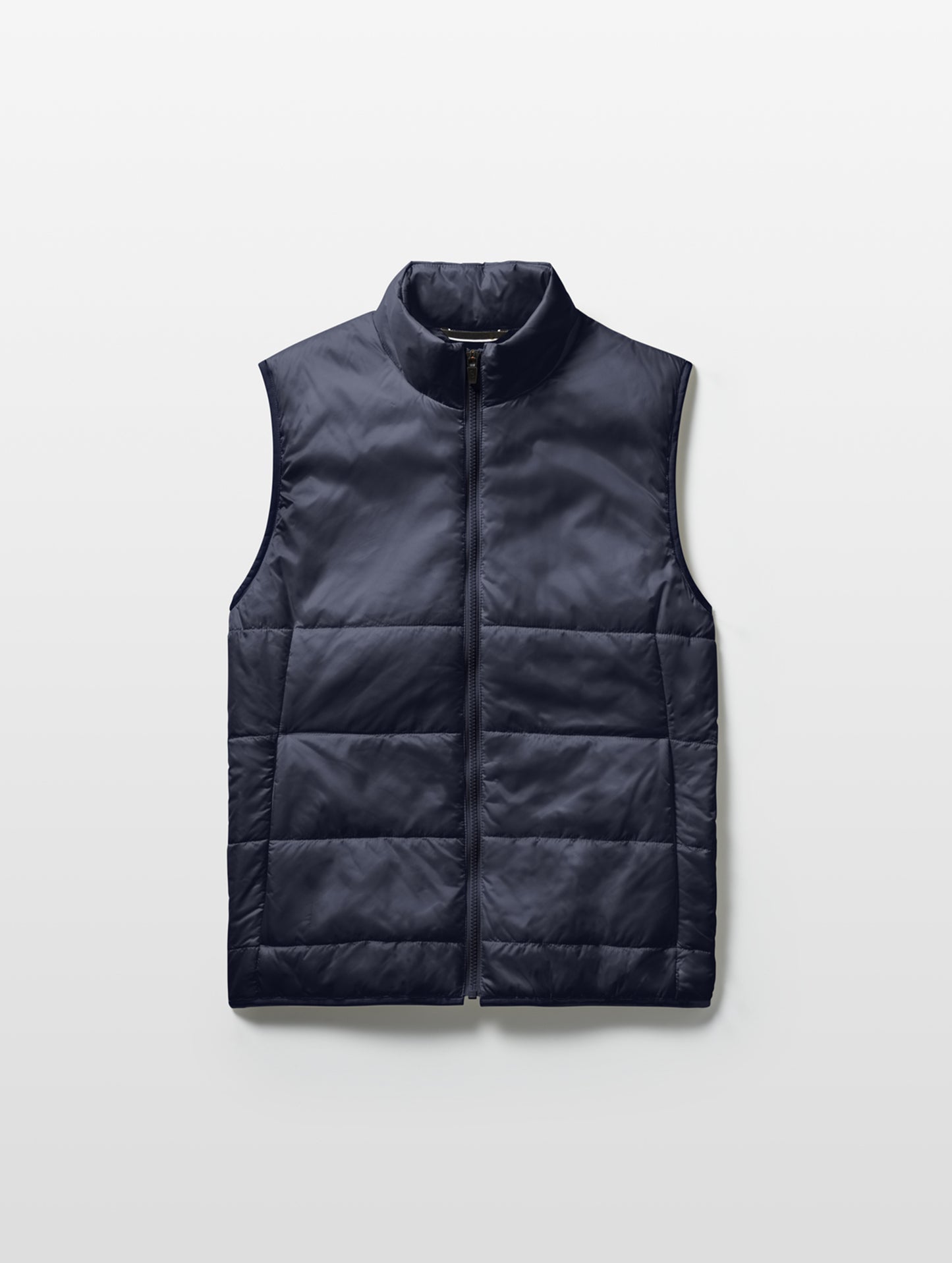 Flat lay of Eco Insulated Vest in Total Eclipse dark blue from AETHER Apparel.