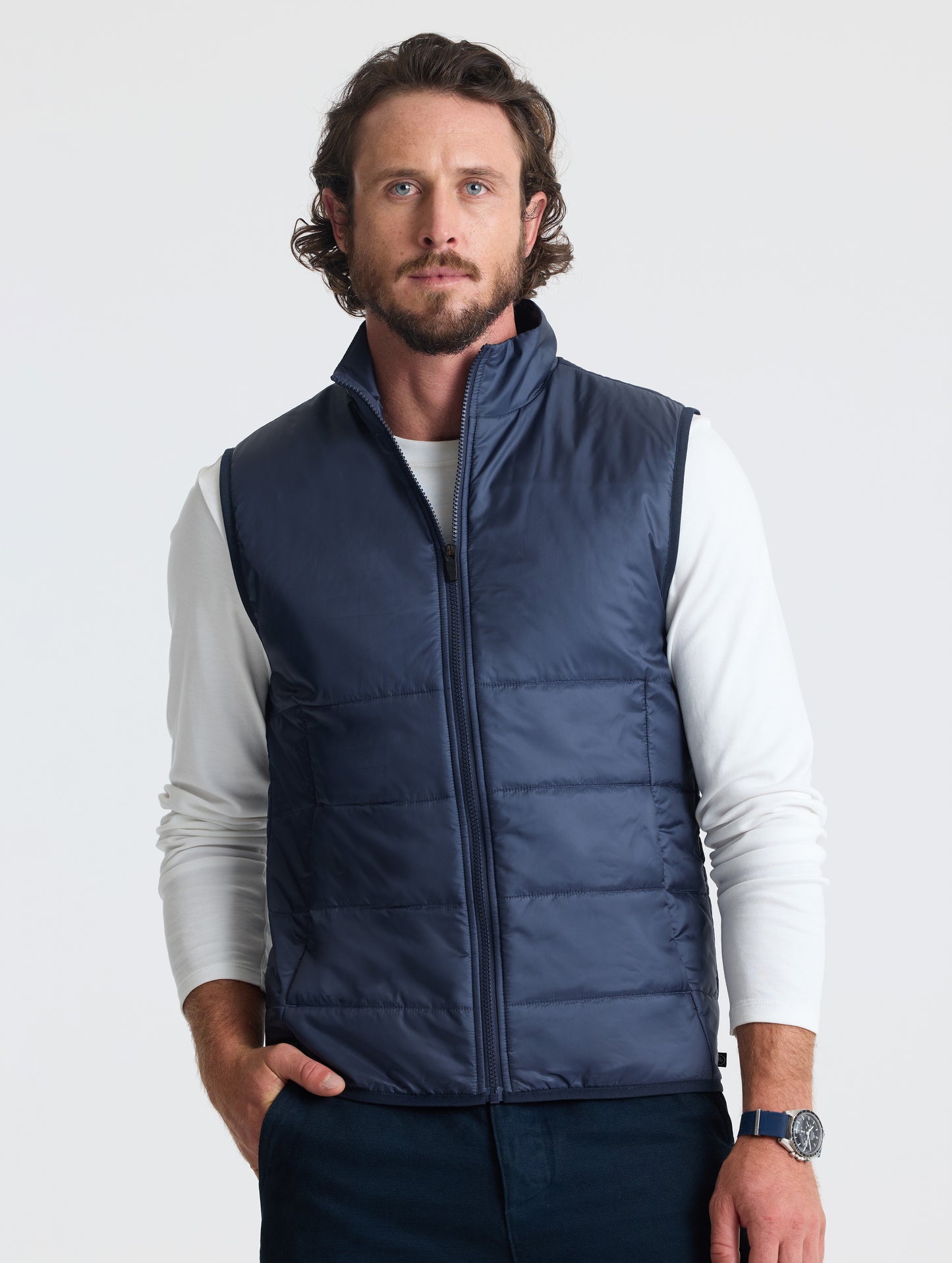 Front view of man wearing Eco Insulated Vest in Total Eclipse dark blue from AETHER Apparel.