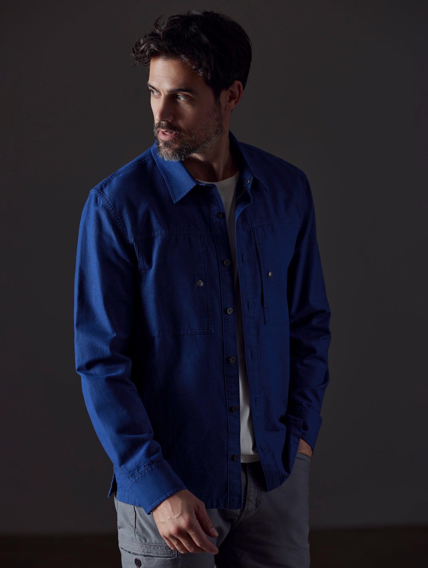 Front 3/4 body view of man wearing Emerson Button Down in Dark Blue from AETHER Apparel.