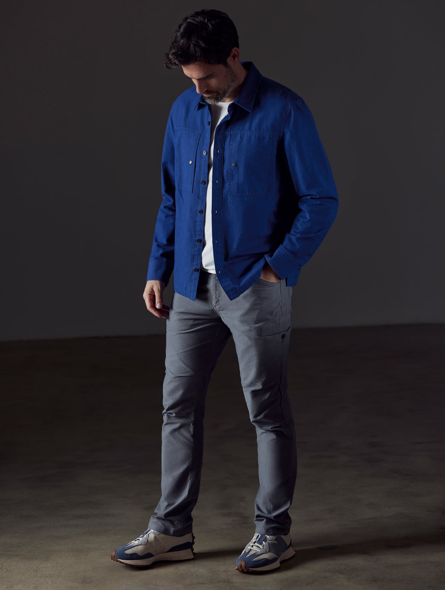 Front 3/4 full-body view of man wearing Emerson Button Down in Dark Blue from AETHER Apparel.