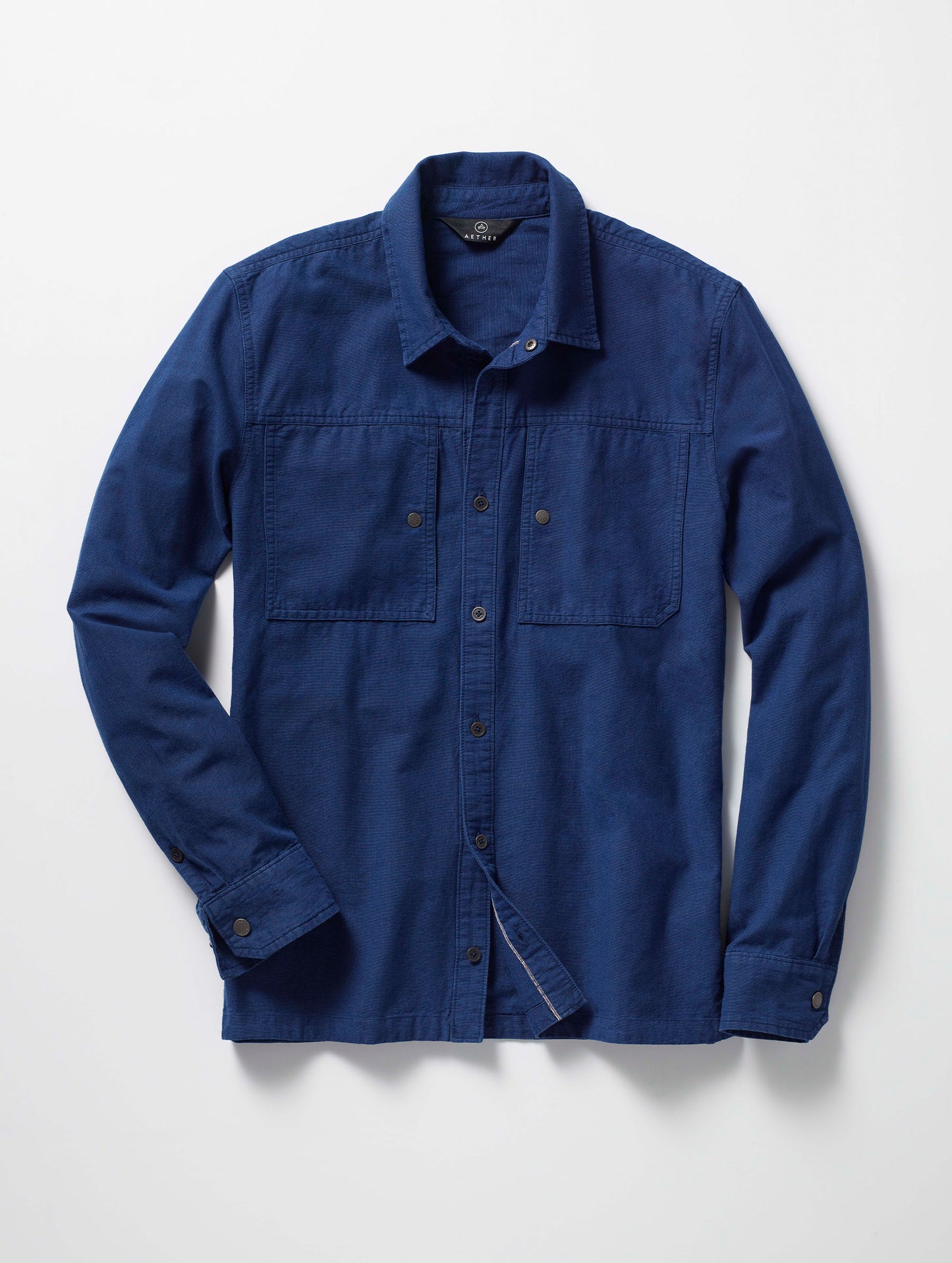 Flay lay of the Emerson Button Down in Dark Blue from AETHER Apparel.