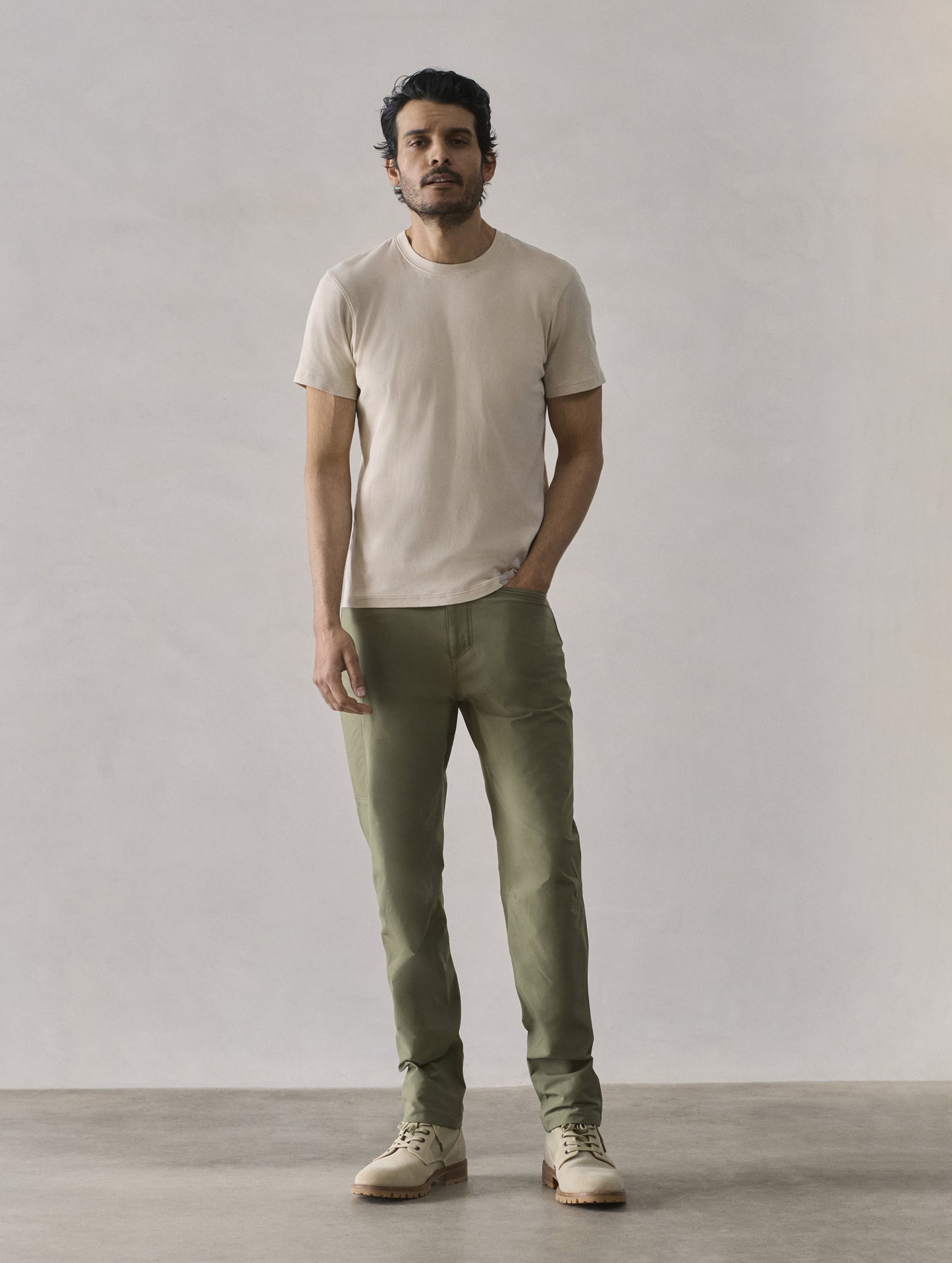 Front full-body view of man wearing Emery Pima Crew Tee in Bone white from AETHER Apparel.