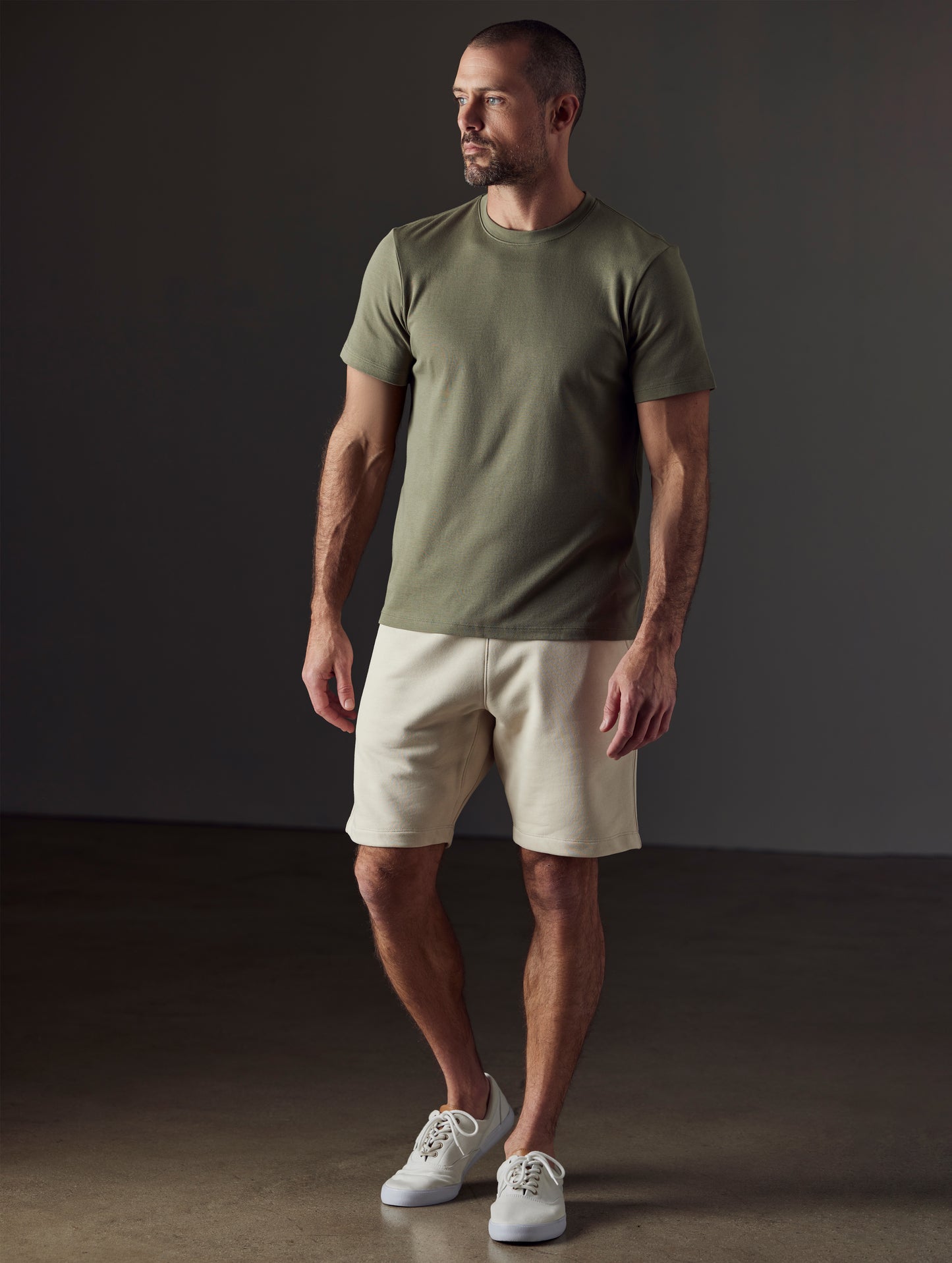 Front full-body view of man wearing Emery Pima Crew Tee in Fern Green from AETHER Apparel.