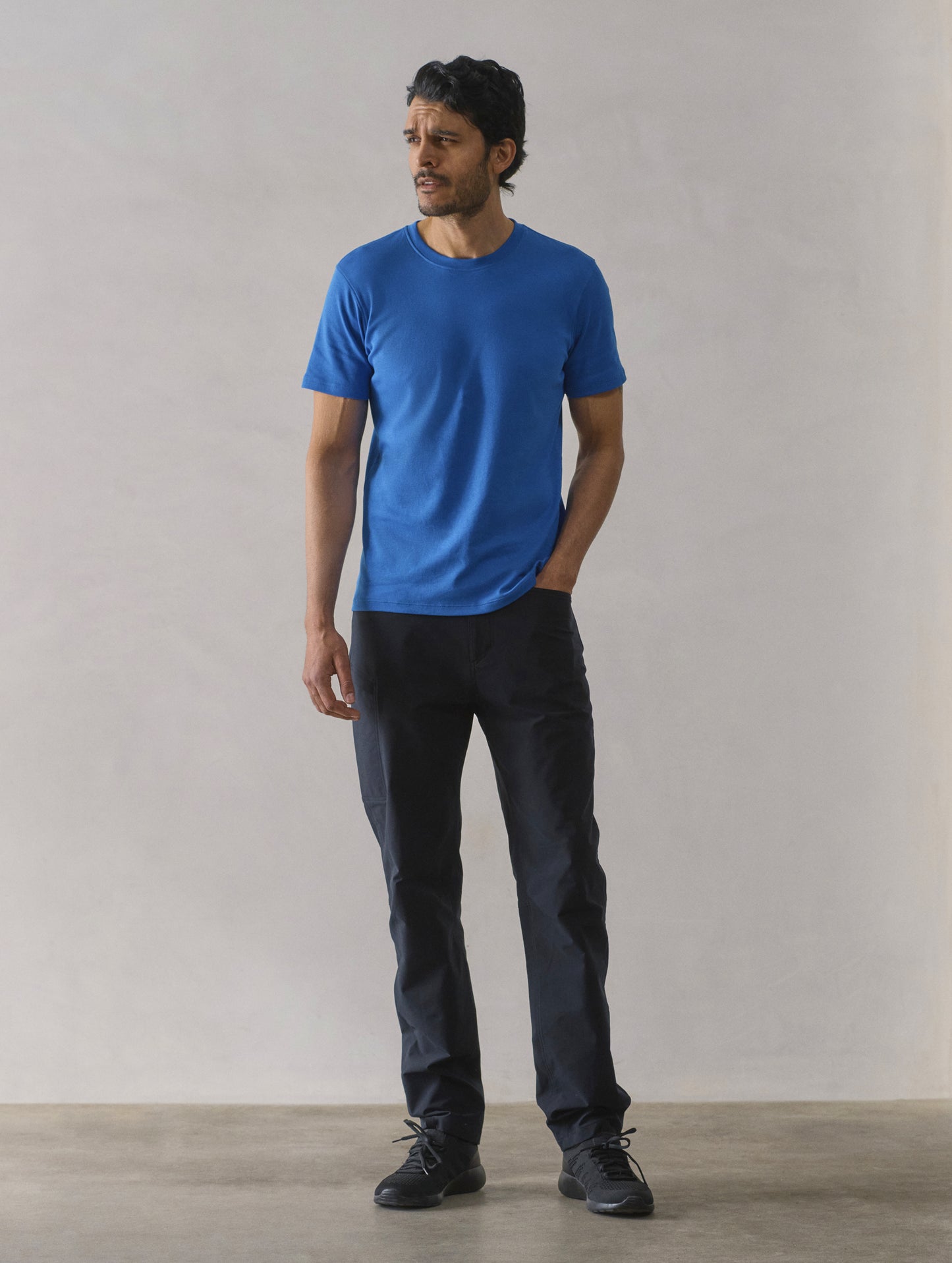 Front full-body view of man wearing Emery Pima Crew Tee in Summit Blue from AETHER Apparel.