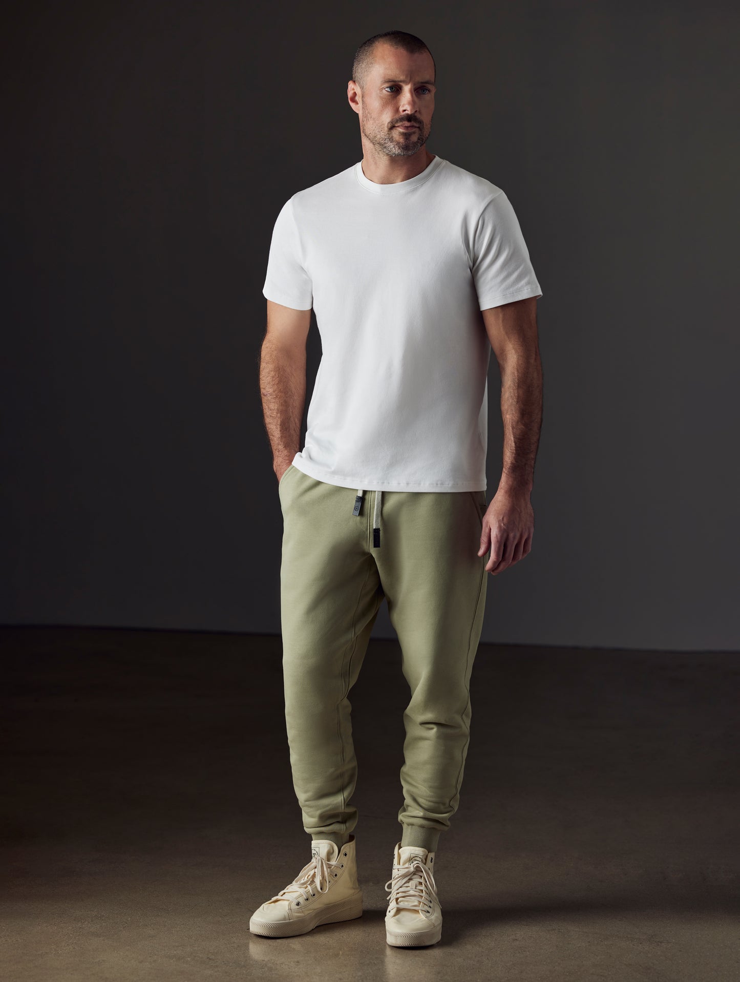 Front full-body view of man wearing Emery Pima Crew Tee in White from AETHER Apparel.