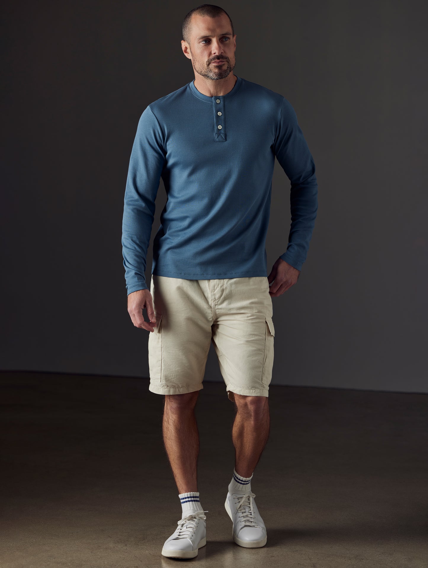 Front full-body view of man wearing Emery Pima Henley in Coastal Blue from AETHER Apparel.