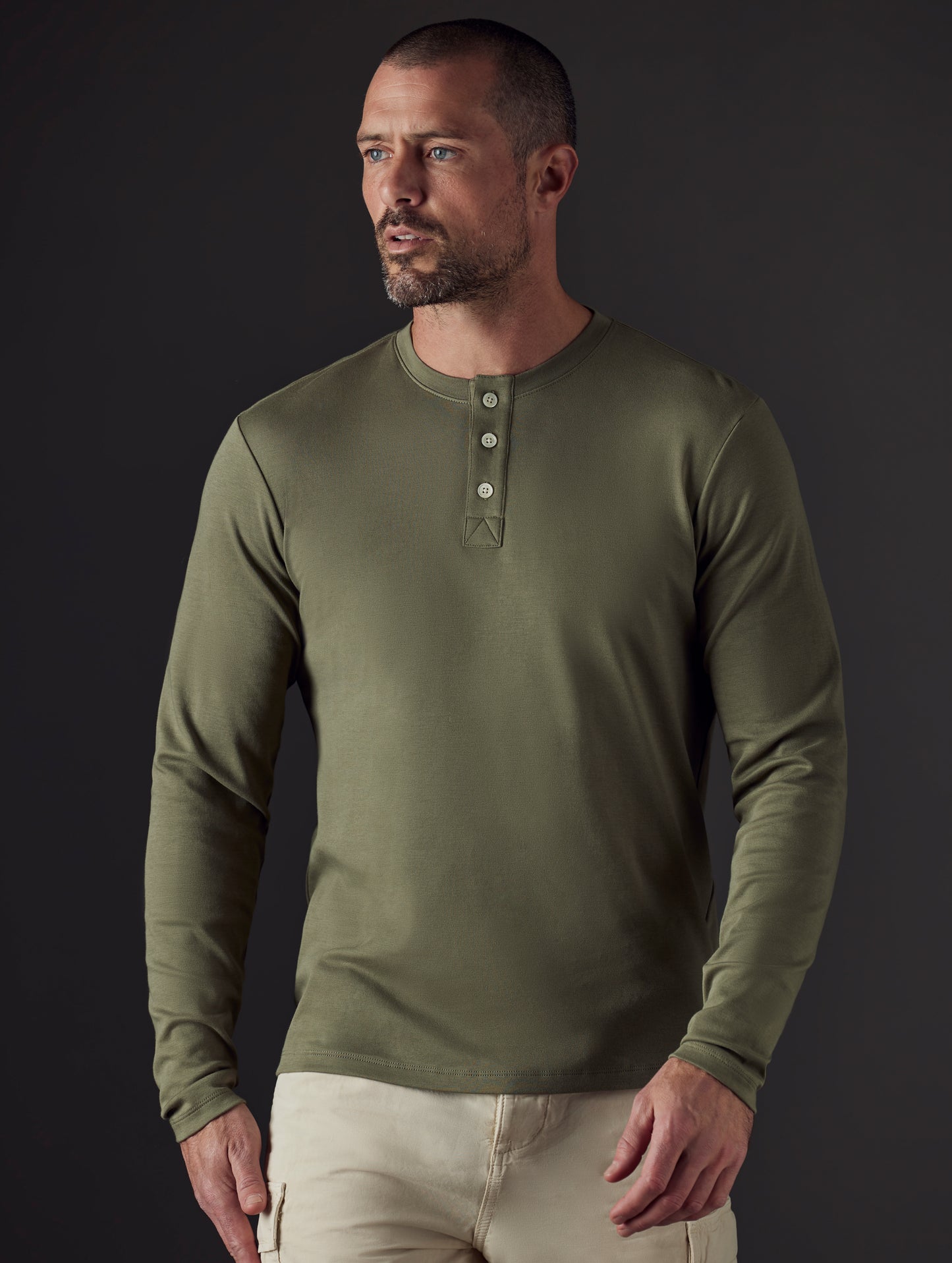 Front body view of man wearing Emery Pima Henley in Fern Green from AETHER Apparel.
