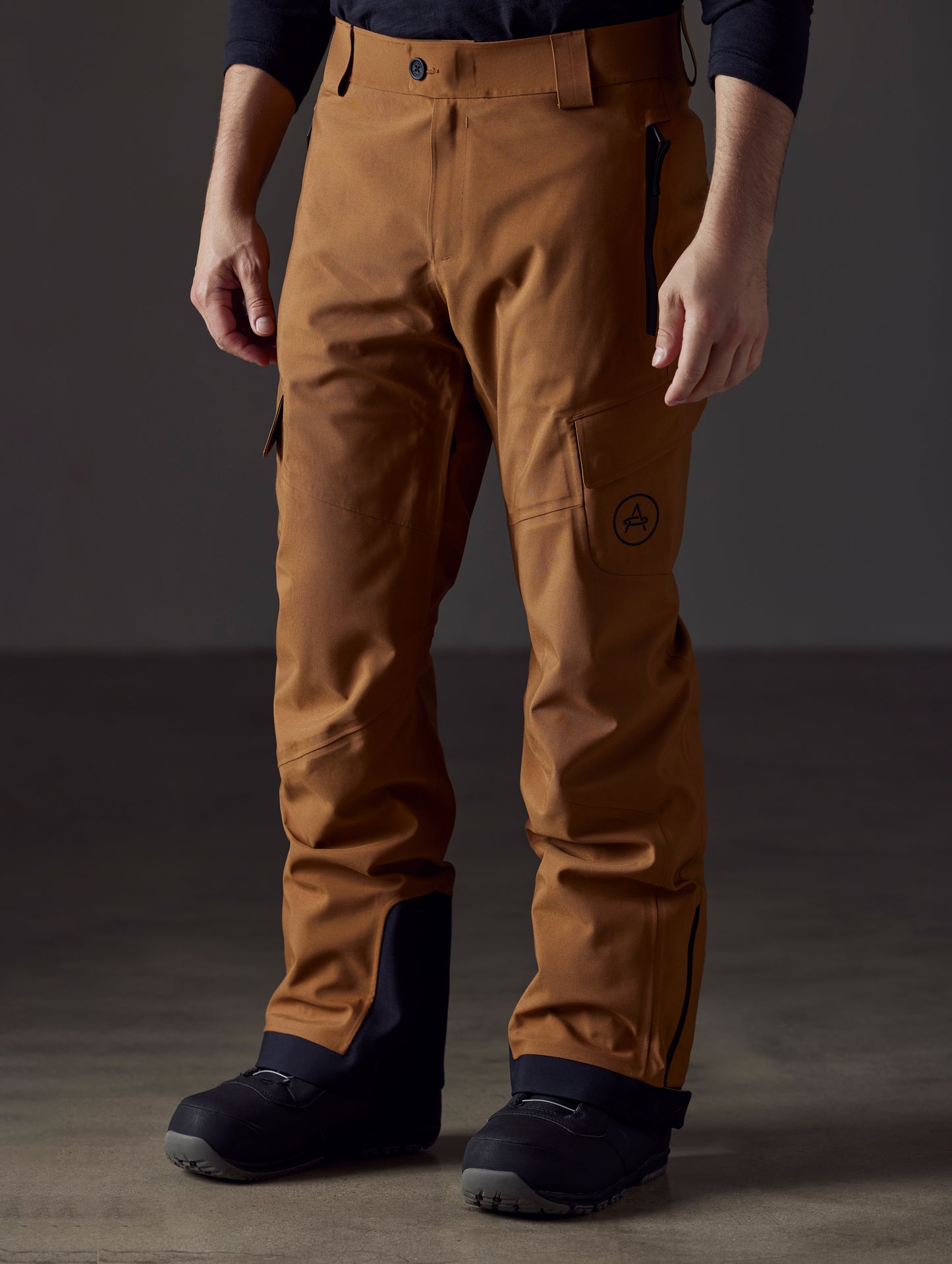 Front angled lower body view of man wearing Explorer Snow Pant in Rubber Brown from AETHER Apparel.