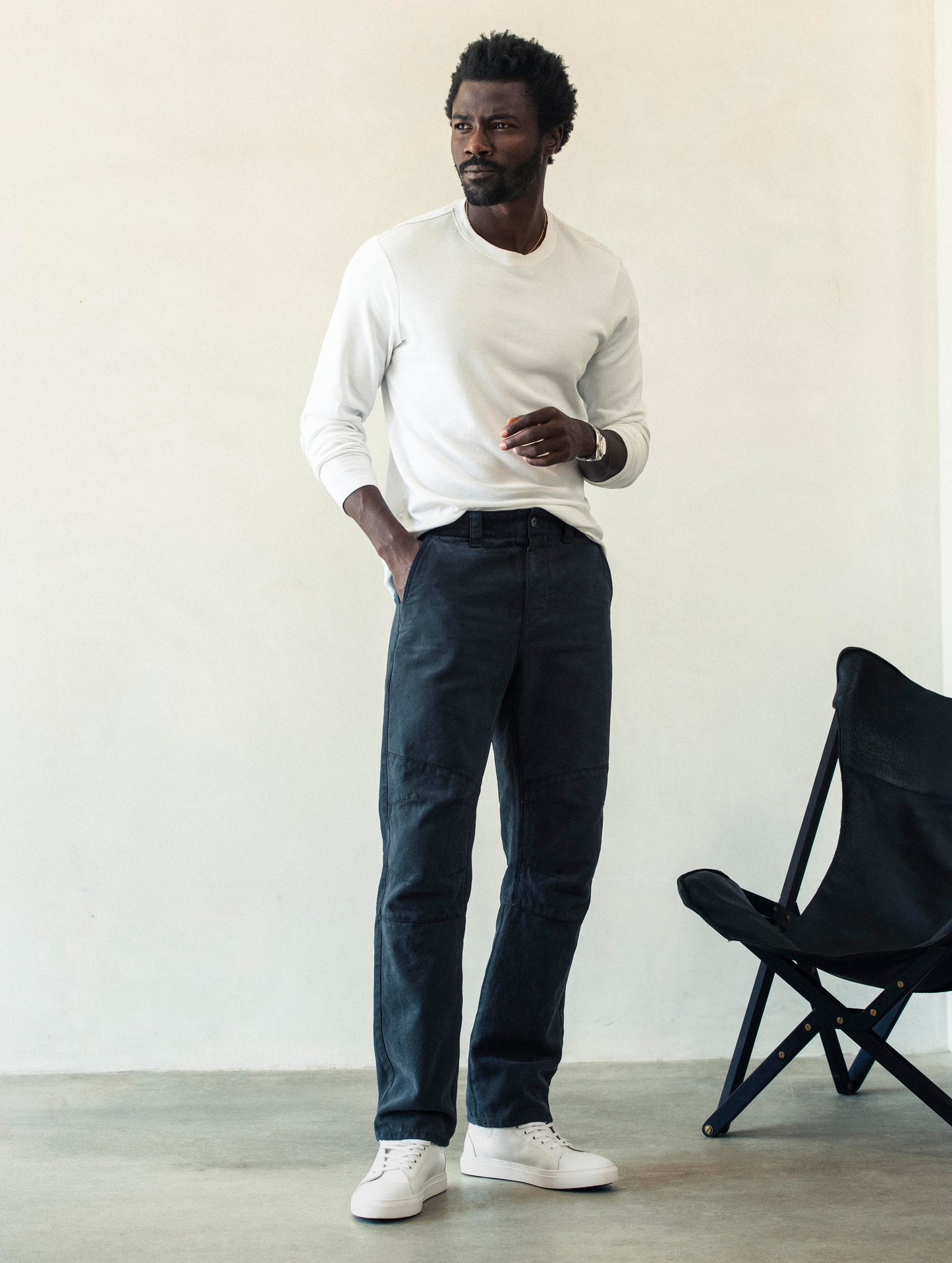 Front full-body view of man wearing Gabriel Articulated Chino Stretch pant in Total Eclipse dark blue from AETHER Apparel.