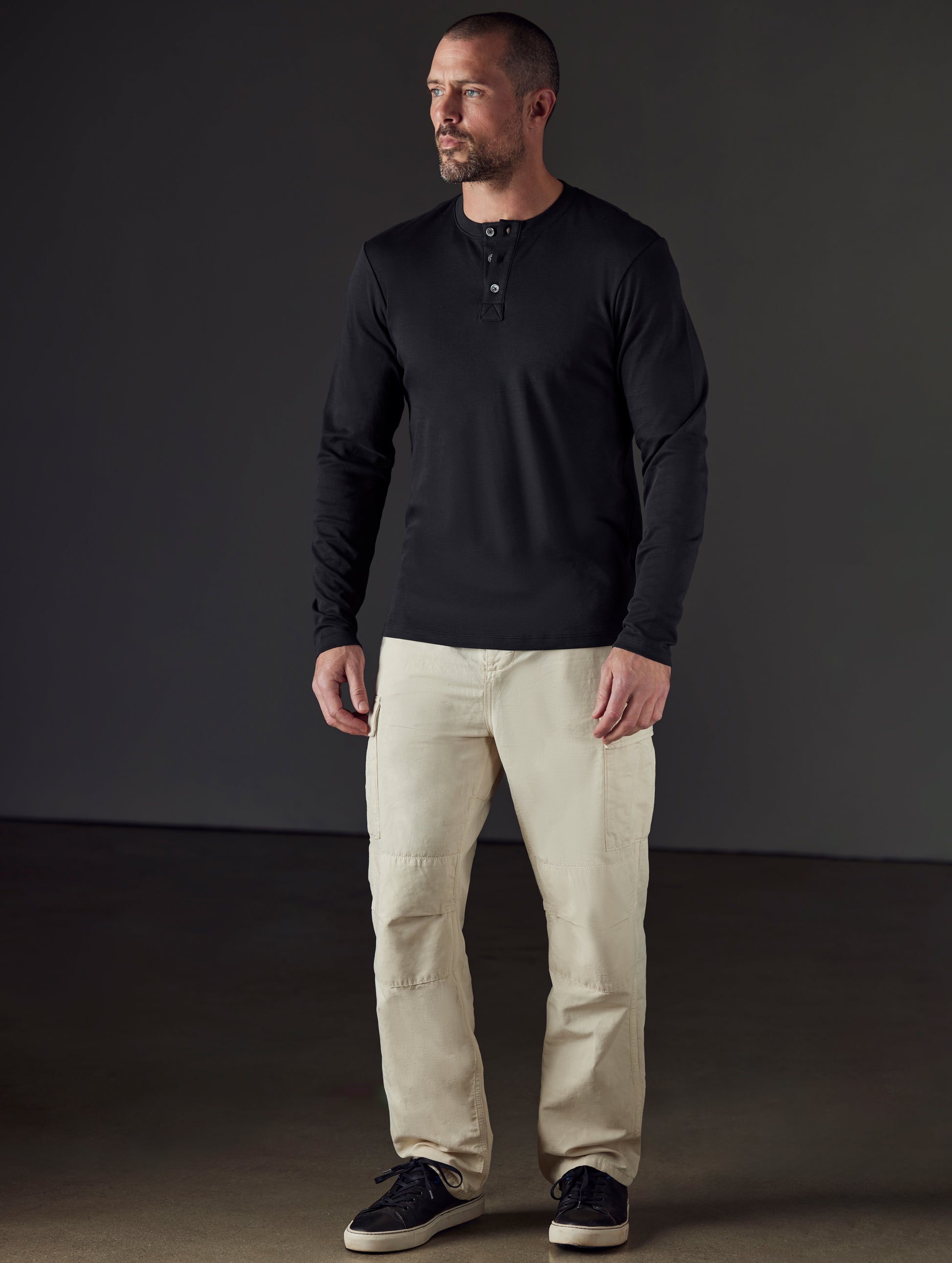 Front 3/4 full-body view of man wearing Glade Fatigue Pant in Bone white from AETHER Apparel.