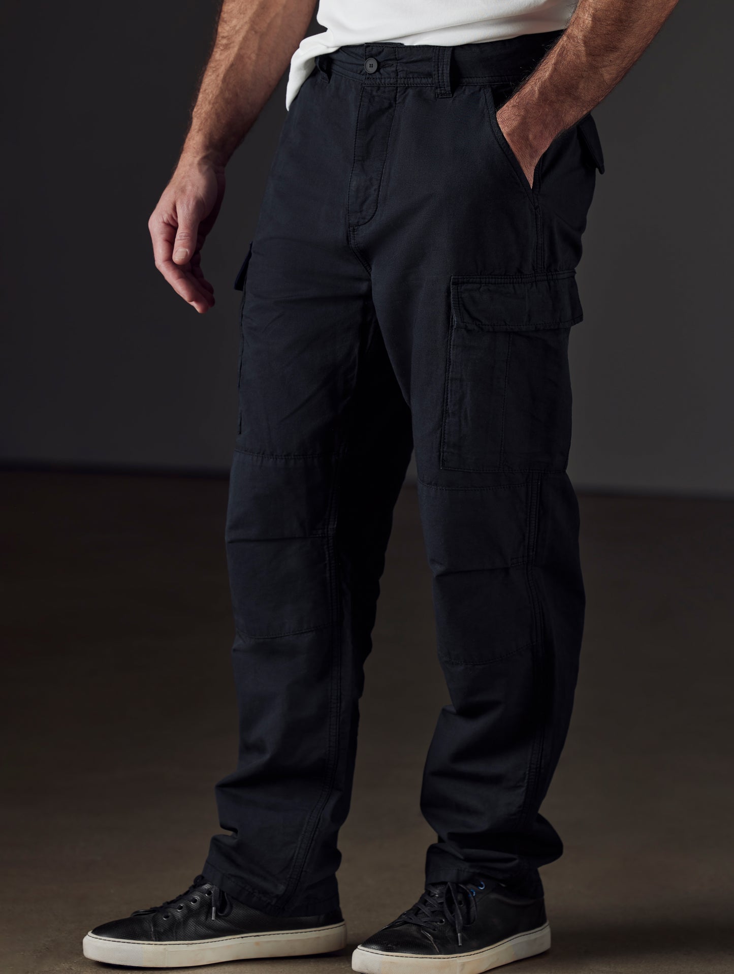 Front 3/4 lower body view of man wearing Glade Fatigue Pant in Onyx Black from AETHER Apparel.