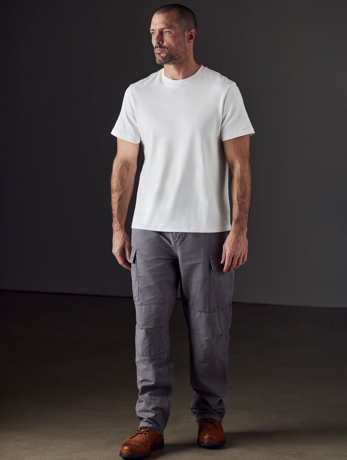 Front 3/4 full-body view of man wearing Glade Fatigue Pant in Storm grey from AETHER Apparel.