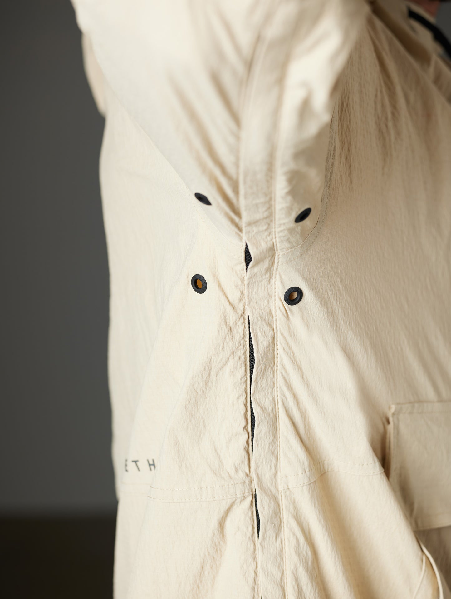Detailed view of under arm, vents, and armpit seam of Harrier Anorak in Desert Tan from AETHER Apparel.