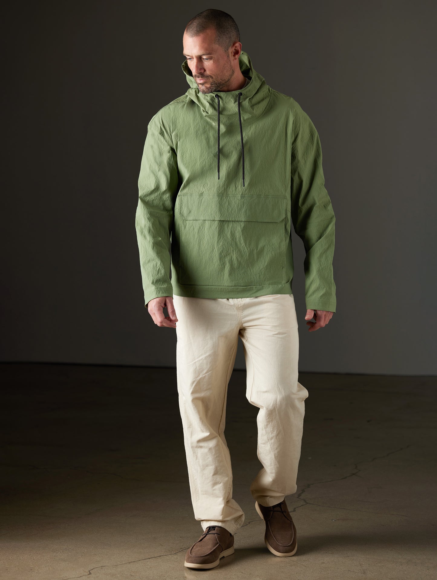 Front full-body view of man wearing Harrier Anorak in Mineral Green from AETHER Apparel.