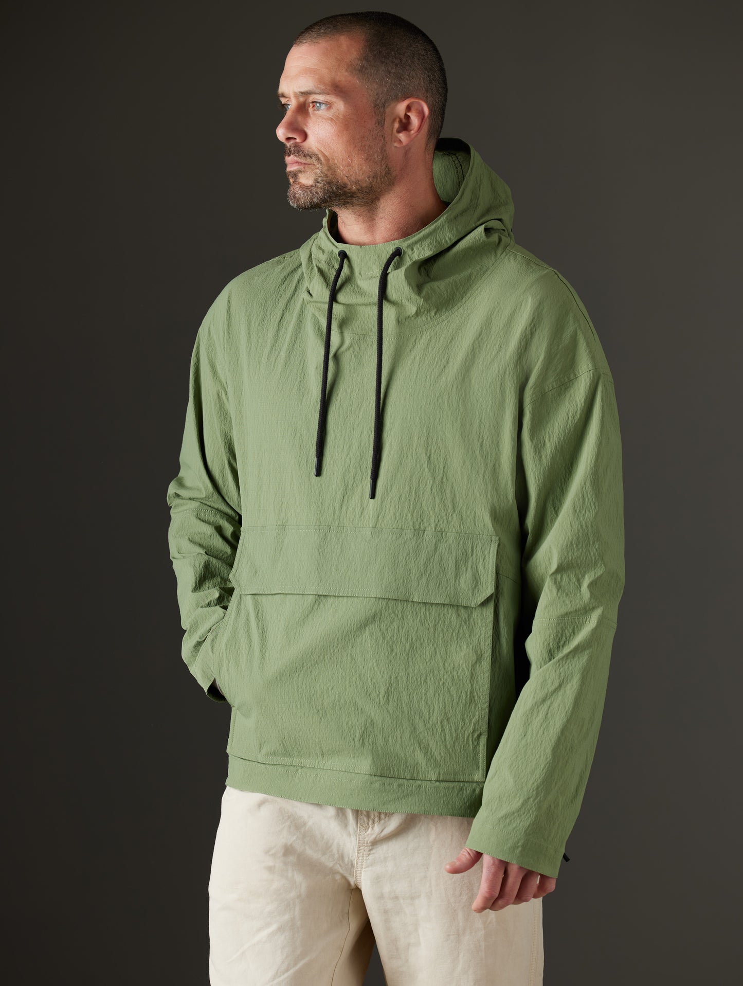 Front body view of man wearing Harrier Anorak in Mineral Green from AETHER Apparel.