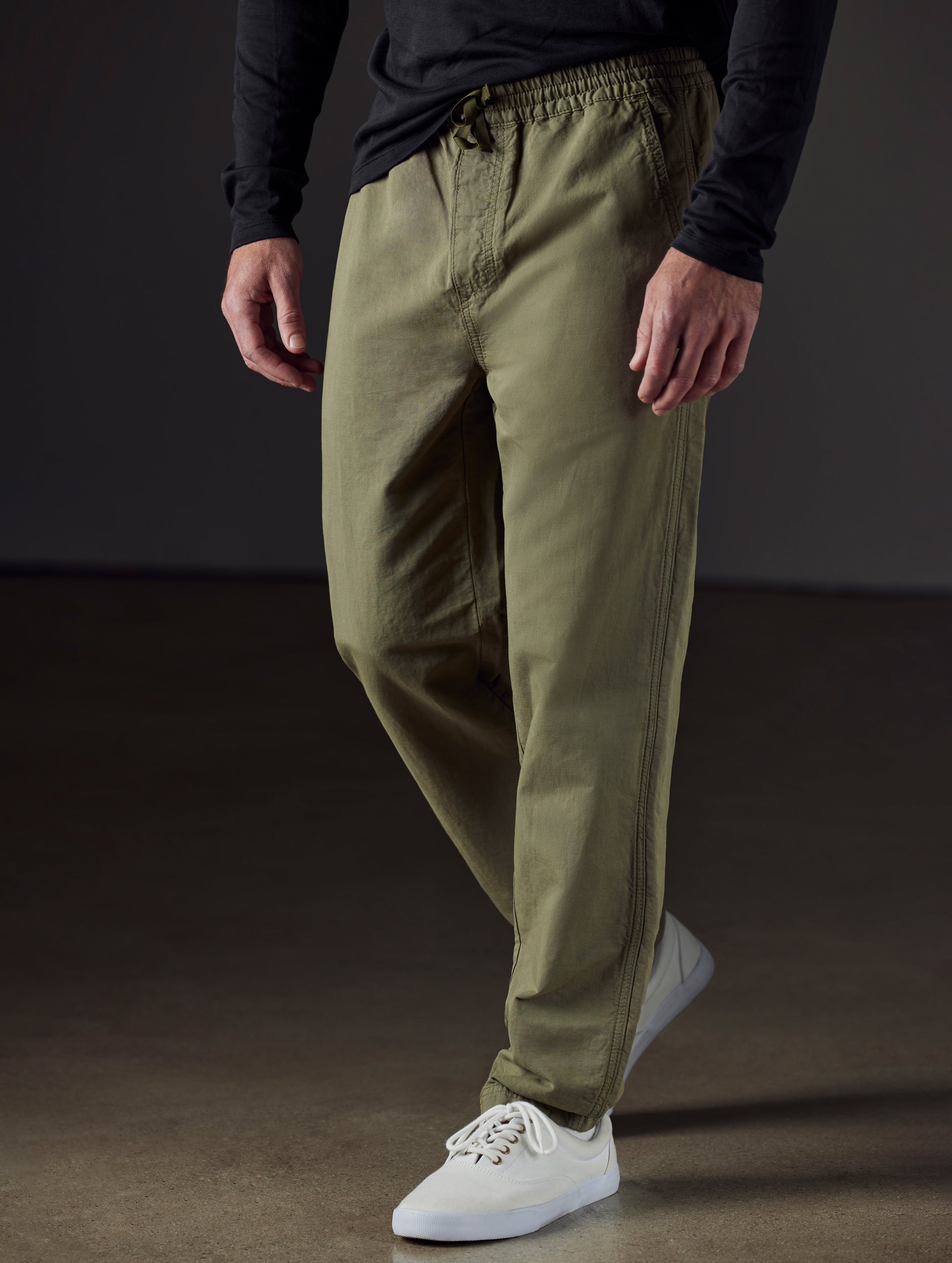 Front 3/4 lower body view of man wearing Highland Drawstring Pant in Fern Green from AETHER Apparel.