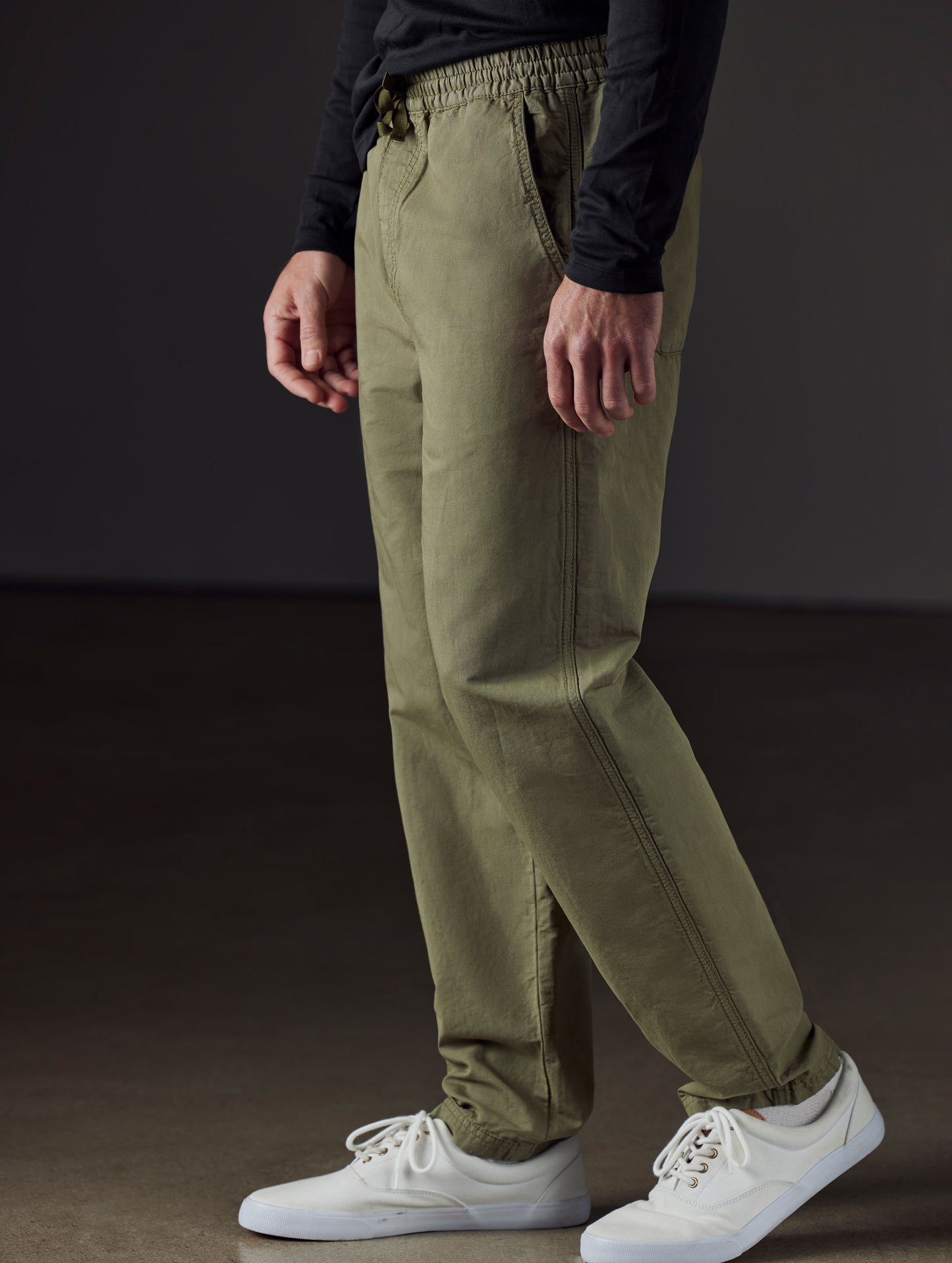 Side profile lower body view of man wearing Highland Drawstring Pant in Fern Green from AETHER Apparel.