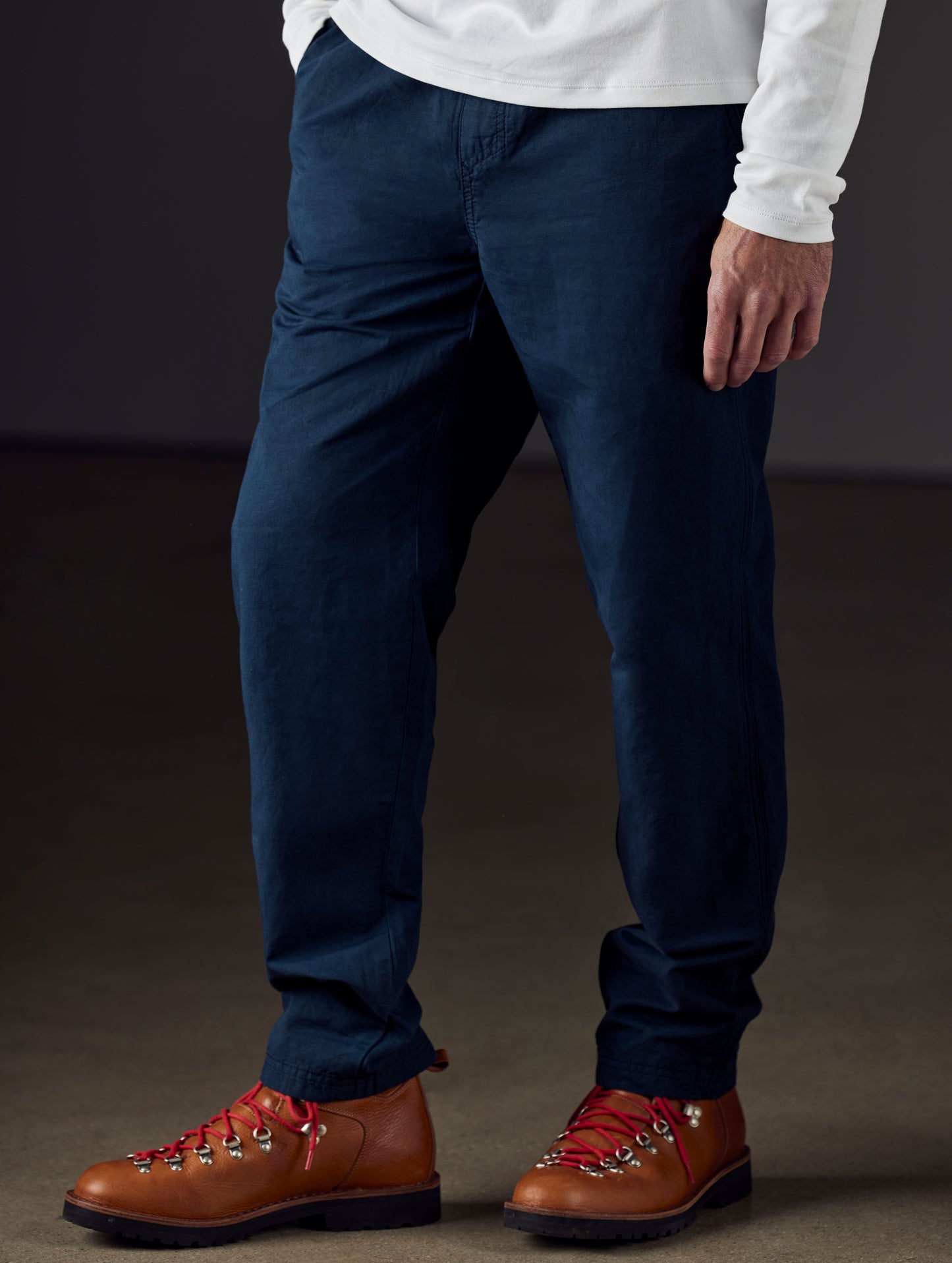Front 3/4 lower body view of man wearing Highland Drawstring Pant in Total Eclipse dark blue from AETHER Apparel.