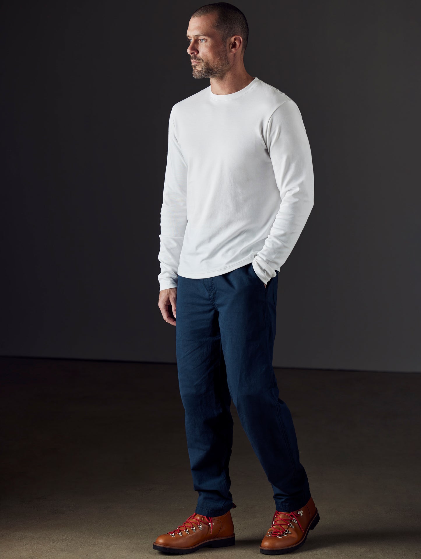 Front 3/4 full-body view of man wearing Highland Drawstring Pant in Total Eclipse dark blue from AETHER Apparel.