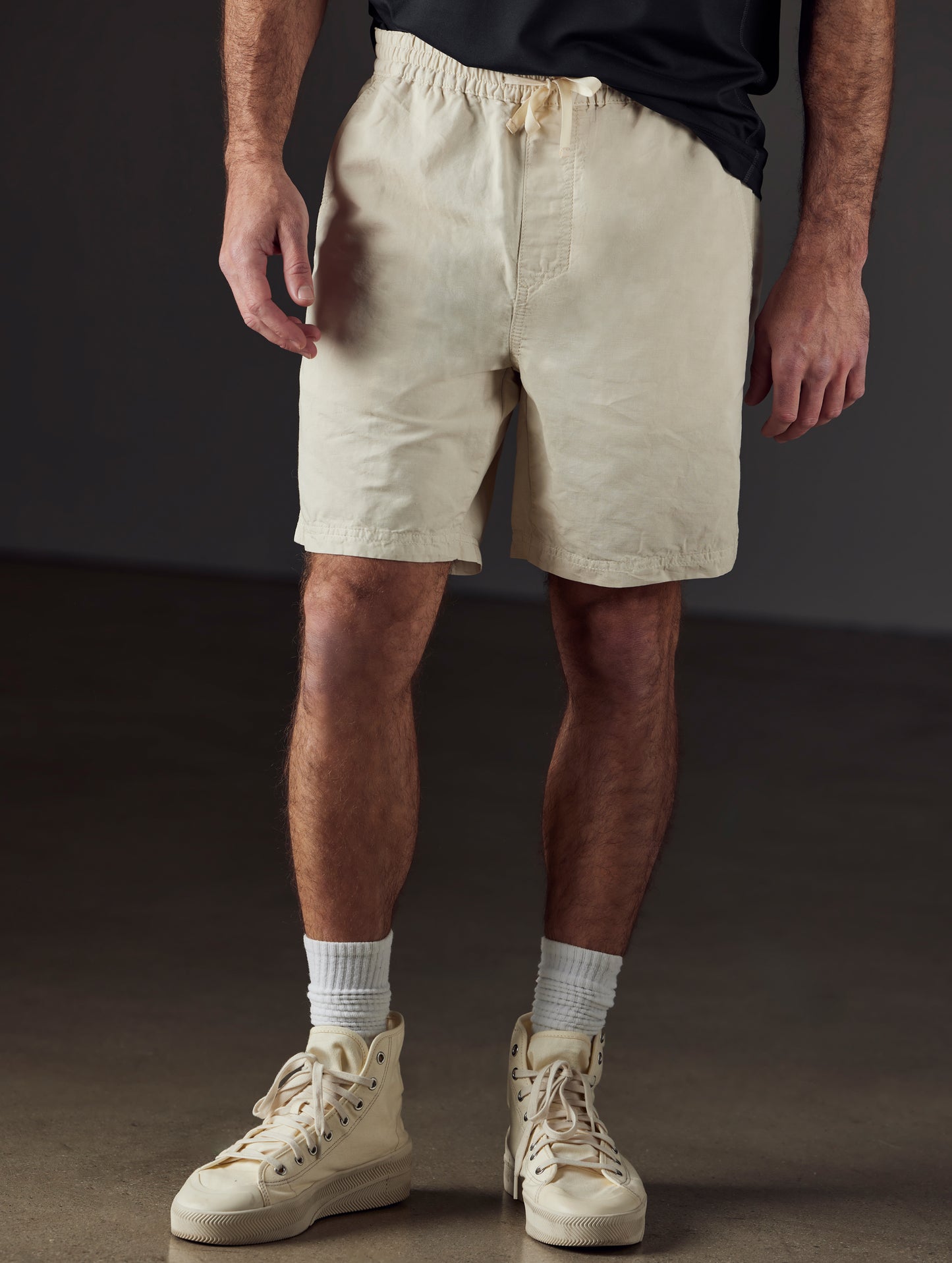 Front lower body view of man wearing Highland Drawstring Short in Bone white from AETHER Apparel.