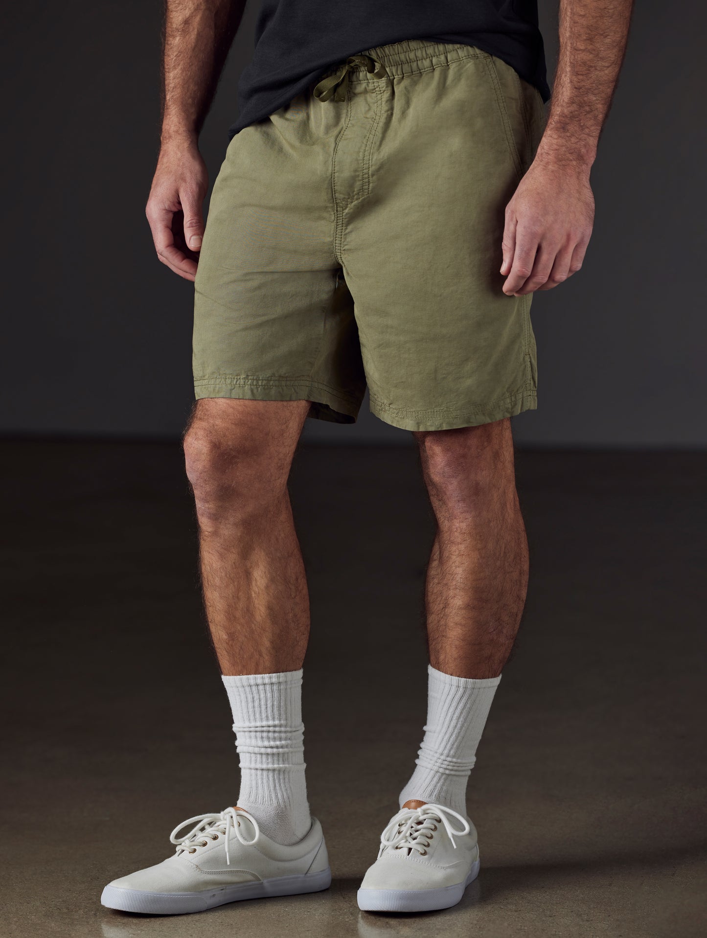 Front lower body view of man wearing Highland Drawstring Short in Fern Green from AETHER Apparel.