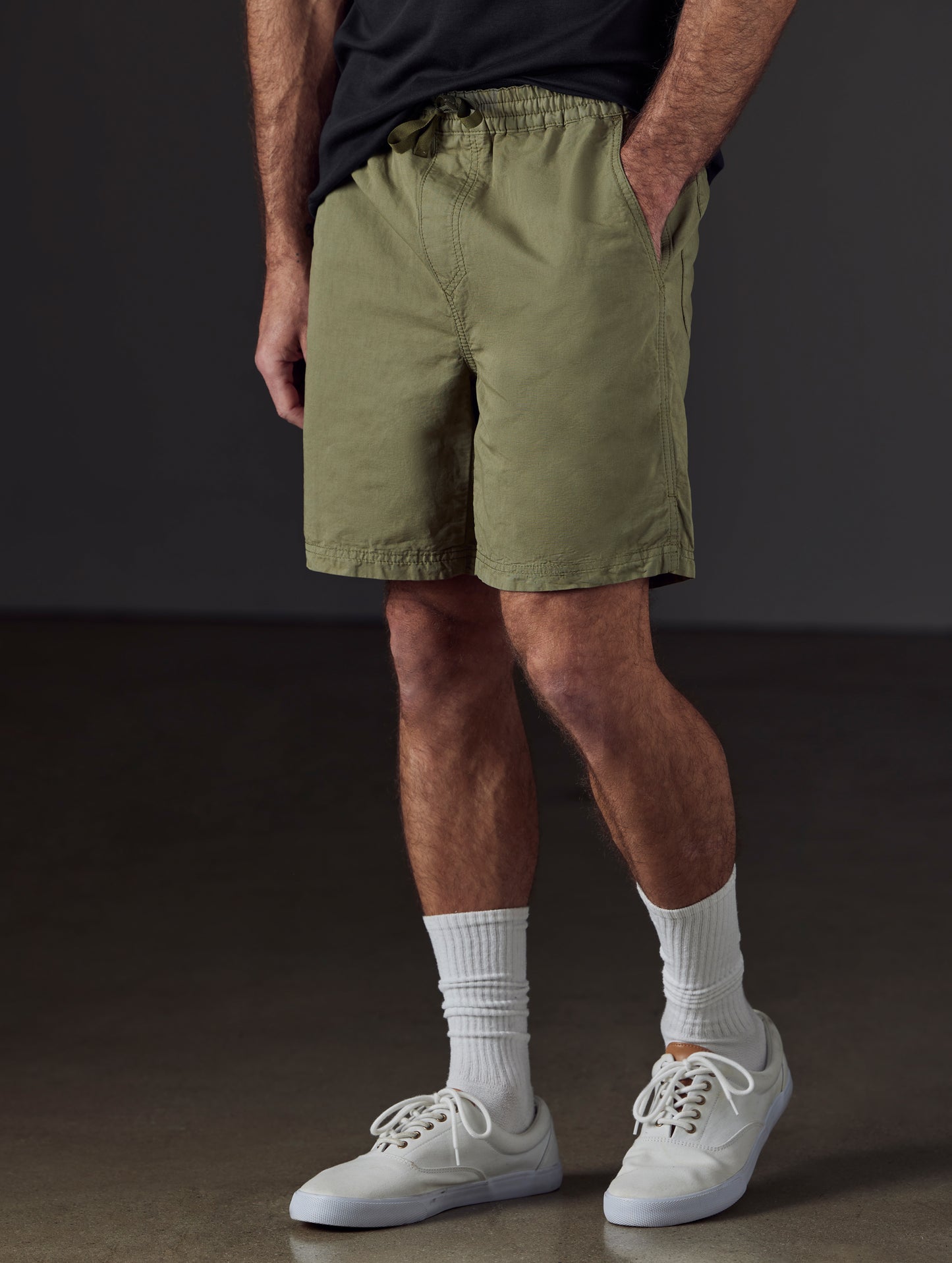 Front 3/4 lower body view of man wearing Highland Drawstring Short in Fern Green from AETHER Apparel.