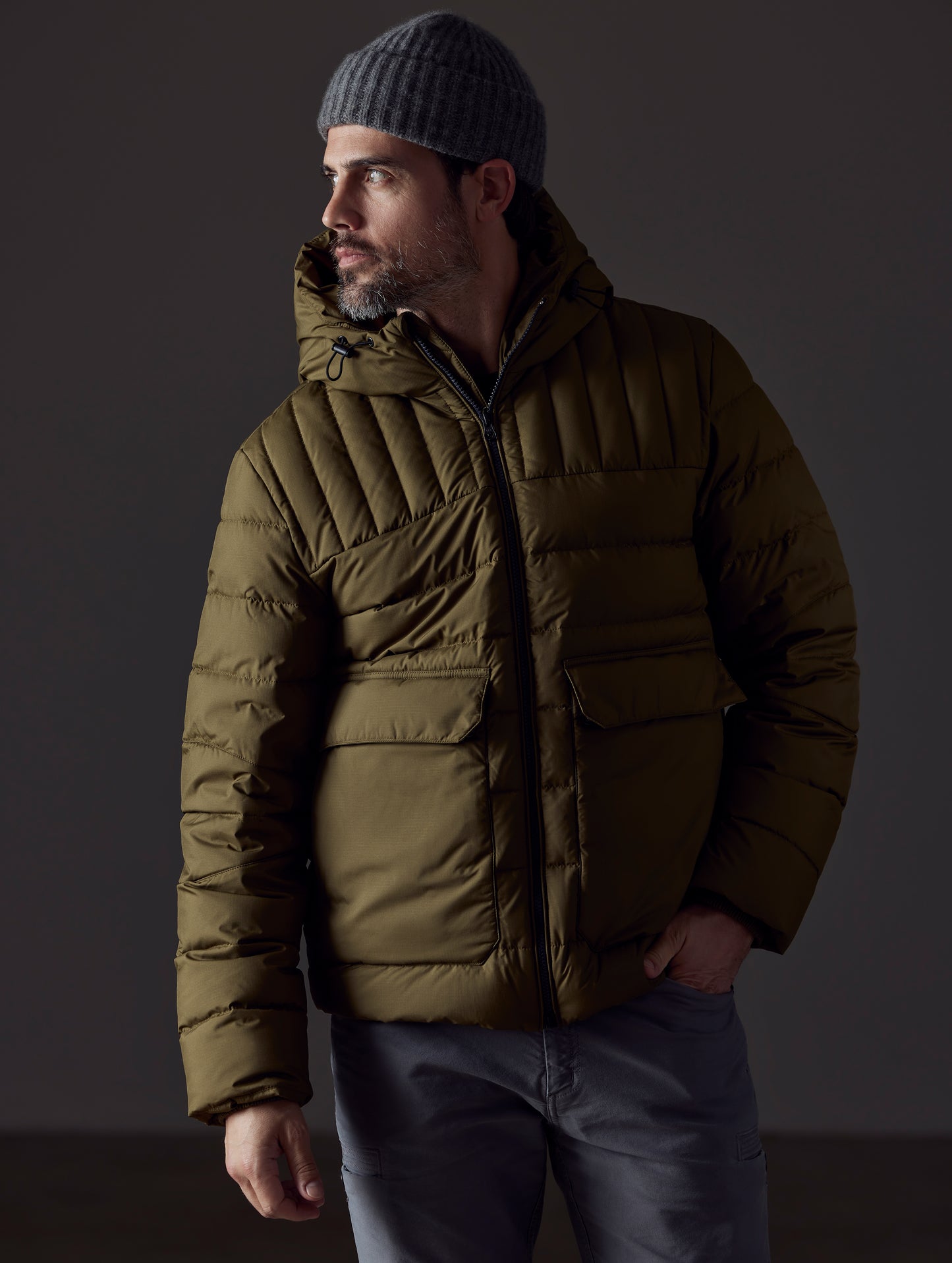 Front body view of man wearing Hudson Down Jacket in Command Green from AETHER Apparel.