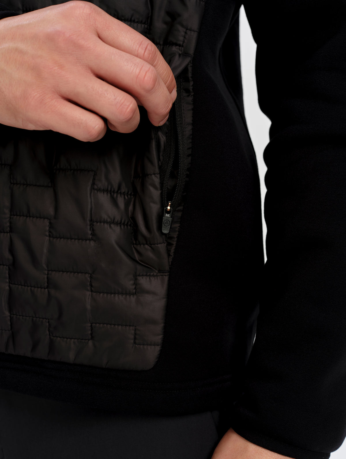 Closeup detailed view of the zippered side pocket on the Hybrid Tech Anorak in Onyx Black from AETHER Apparel.