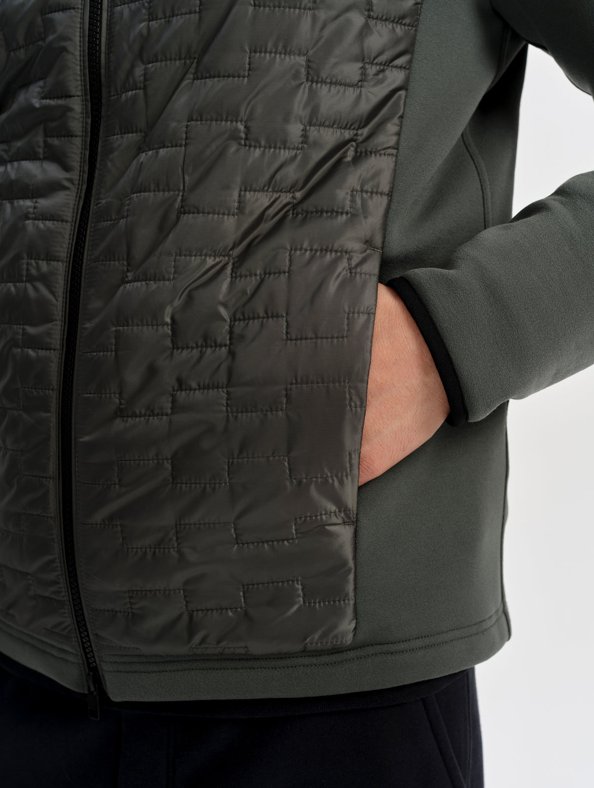 Closeup detailed view of the zippered hand pocket on the Hybrid Tech Full-Zip 2.0 in Saville Green from AETHER Apparel.