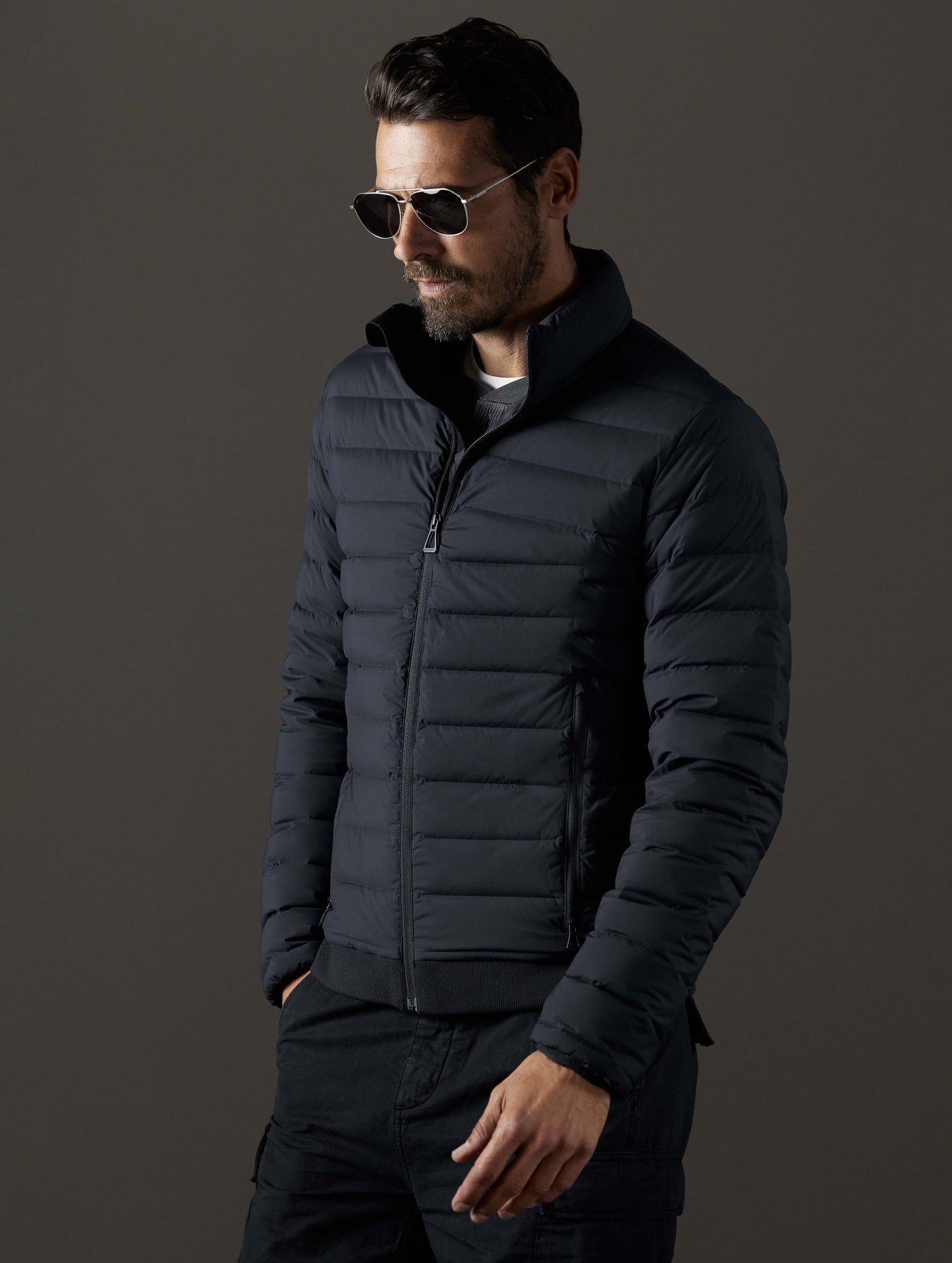 Front 3/4 body view of man wearing Launch Full-Zip Jacket NH in Onyx Black from AETHER Apparel.