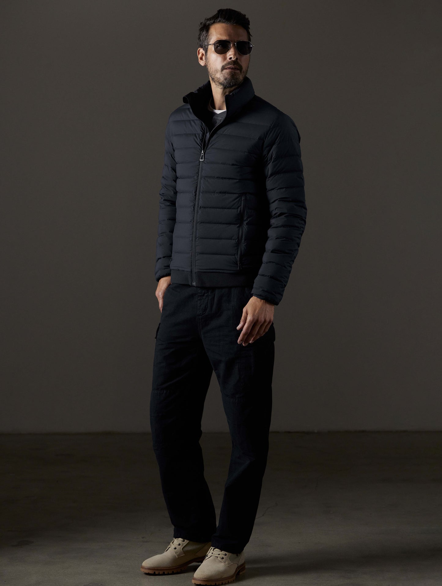 Front 3/4 full-body view of man wearing Launch Full-Zip Jacket NH in Onyx Black from AETHER Apparel.