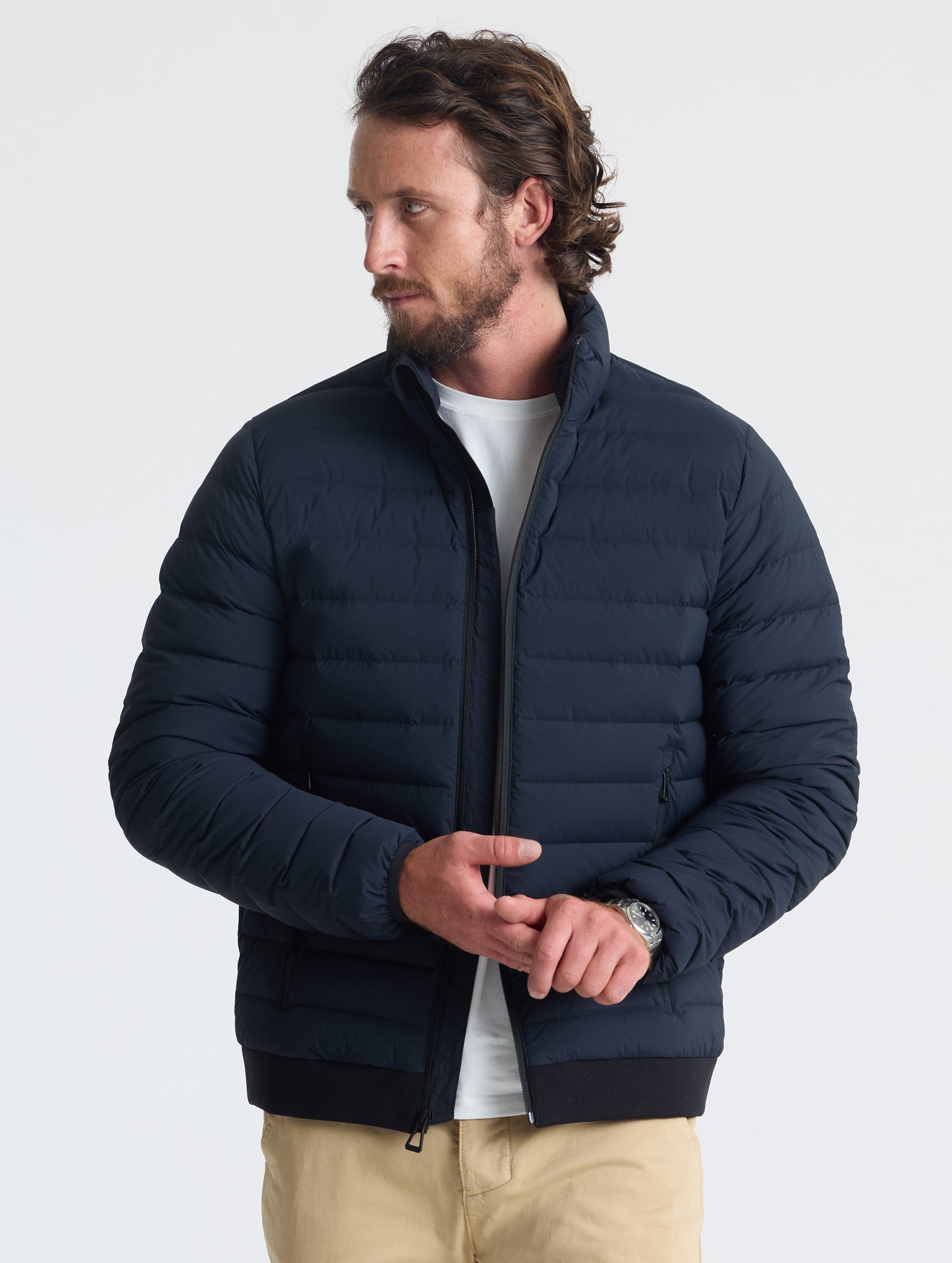 Front view of man wearing unzipped Launch Jacket in Onyx Black from AETHER Apparel.