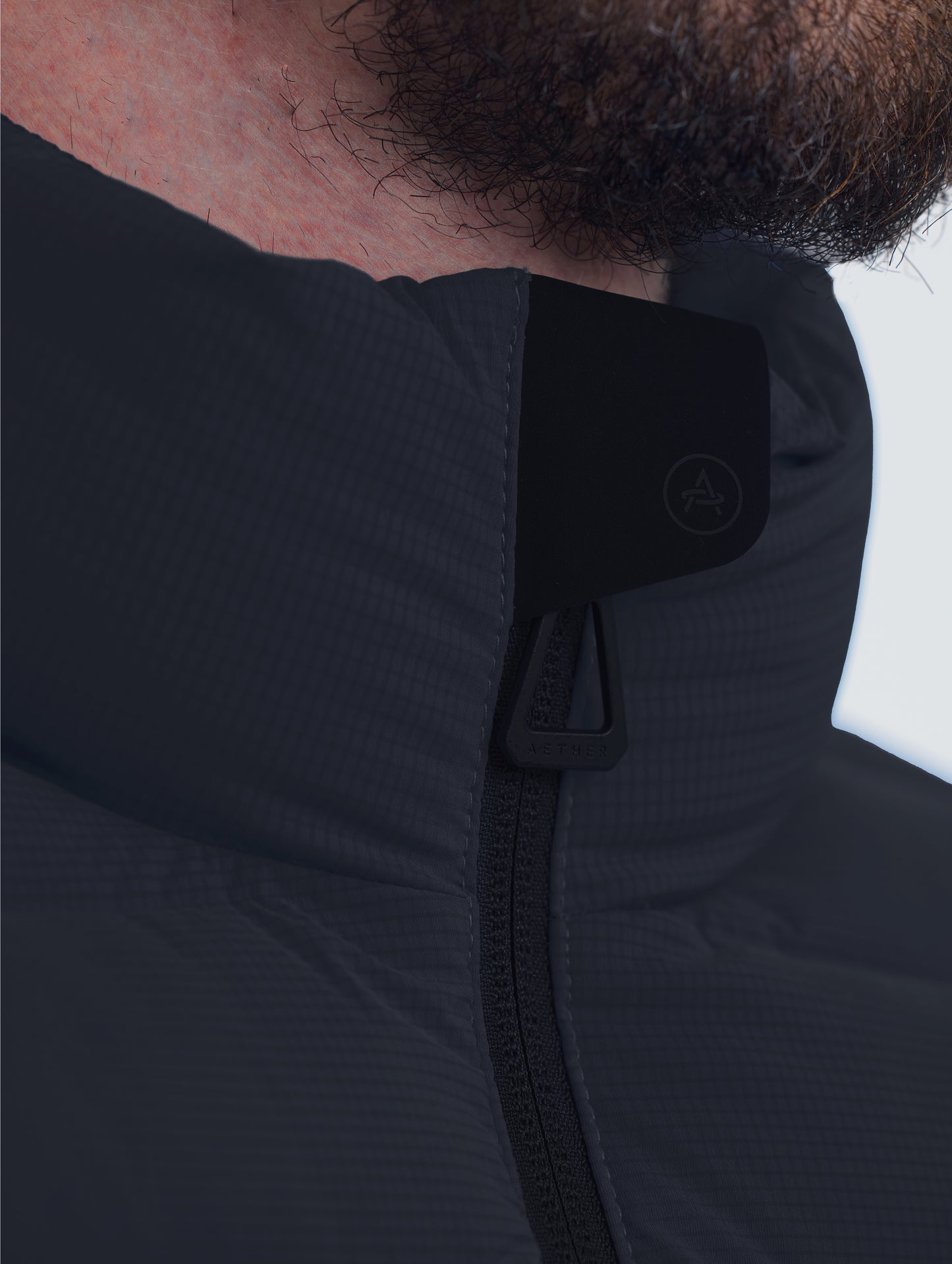 Closeup view of collar of Launch Jacket in Onyx Black from AETHER Apparel.