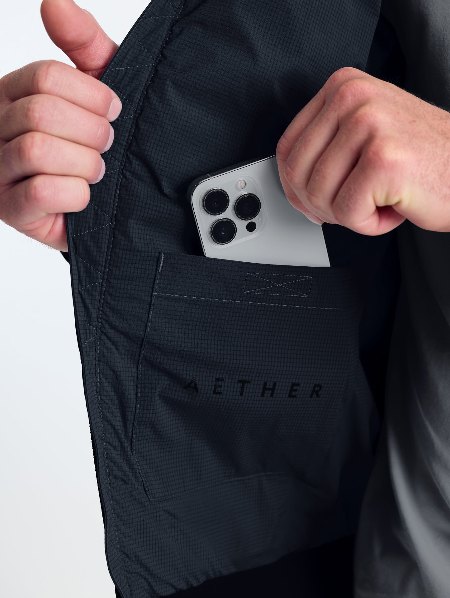 Closeup view of wearer's interior right drop pocket of Launch Jacket in Onyx Black from AETHER Apparel.