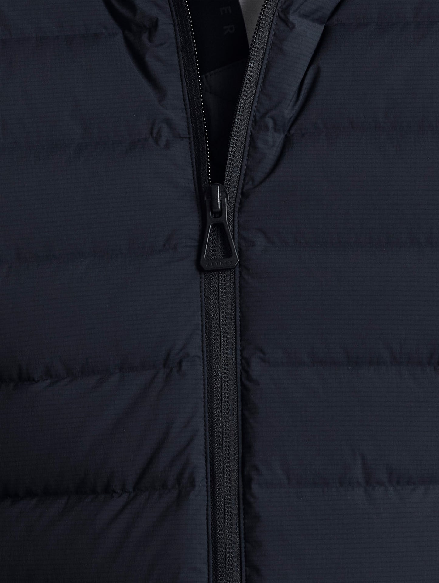 Closeup view of center zipper of Launch Jacket in Onyx Black from AETHER Apparel.