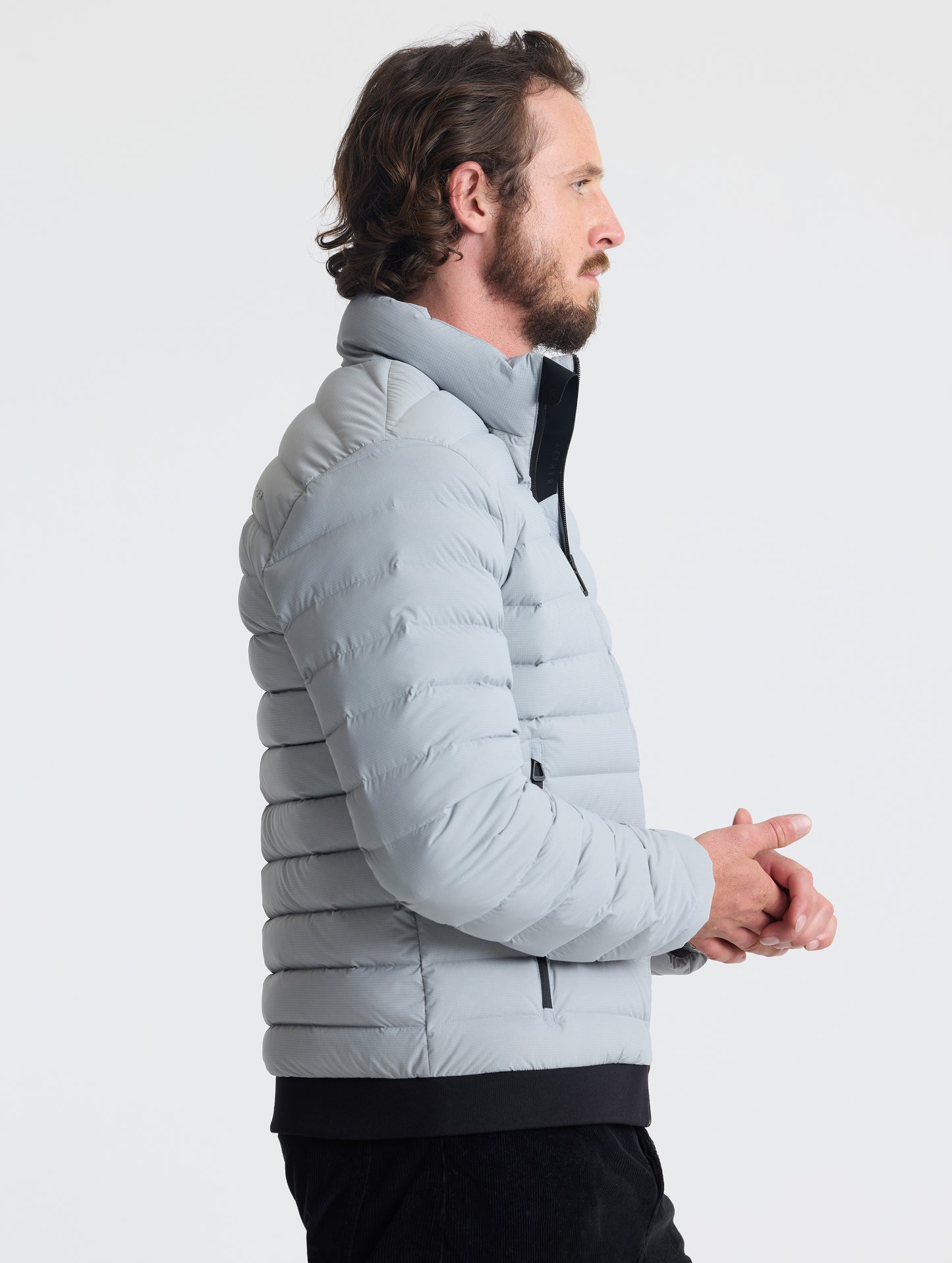 Right profile view of man wearing Launch Jacket in Sky Grey from AETHER Apparel.