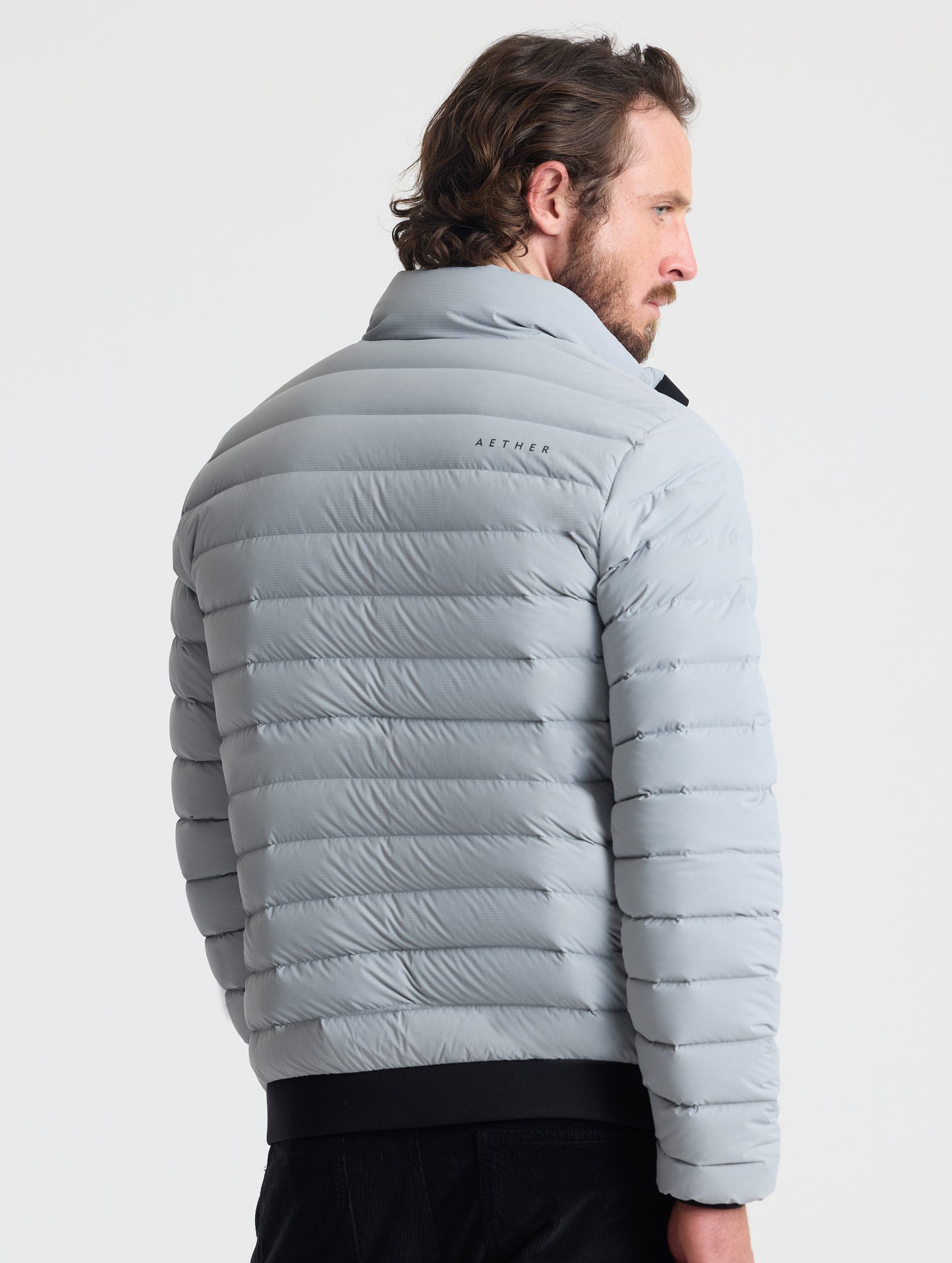 Rear view of man wearing Launch Jacket in Sky Grey from AETHER Apparel.