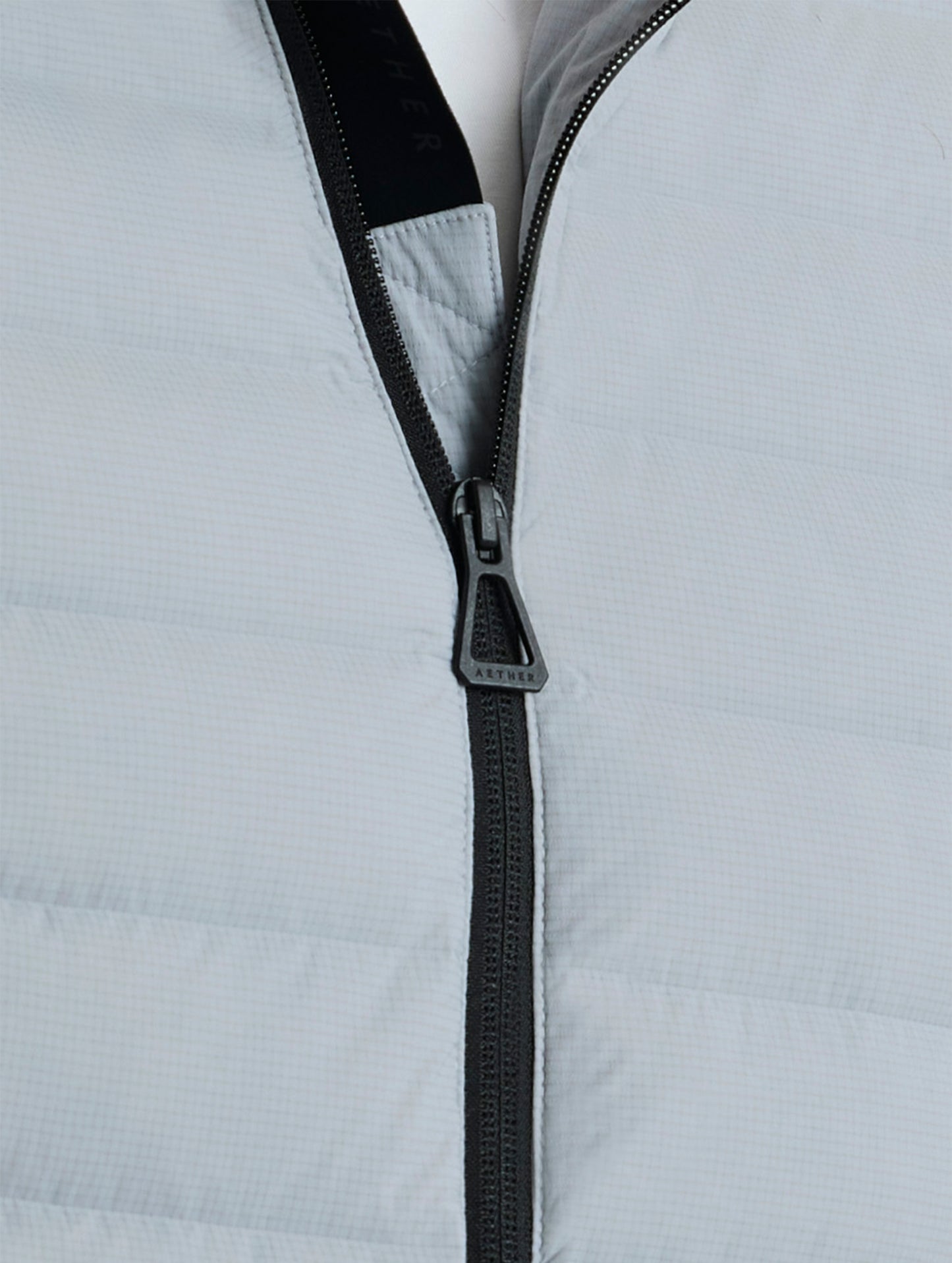 Closeup view of center zipper of Launch Jacket in Sky Grey from AETHER Apparel.