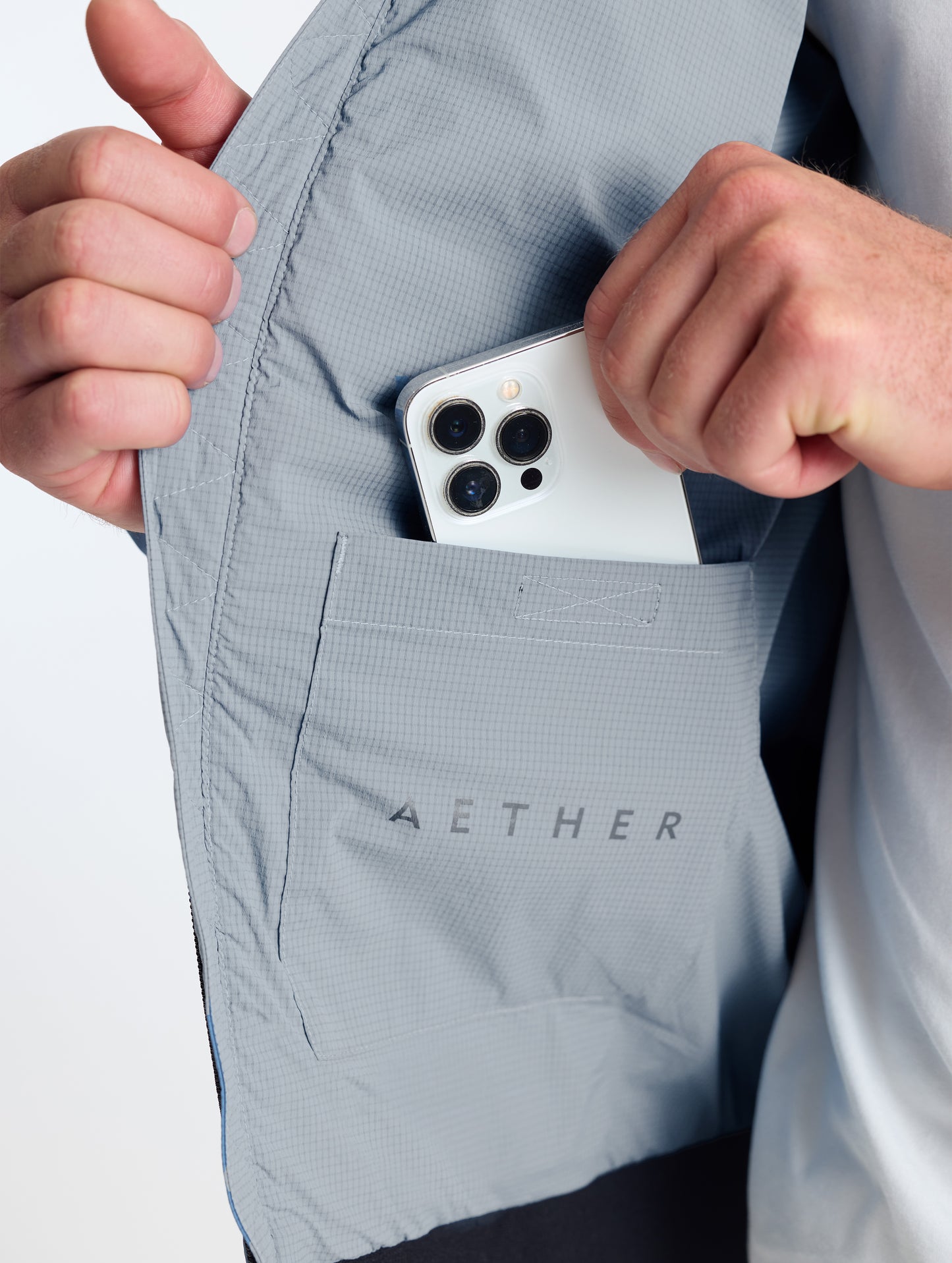 Closeup view of wearer's interior right drop pocket of Launch Jacket in Sky Grey from AETHER Apparel.