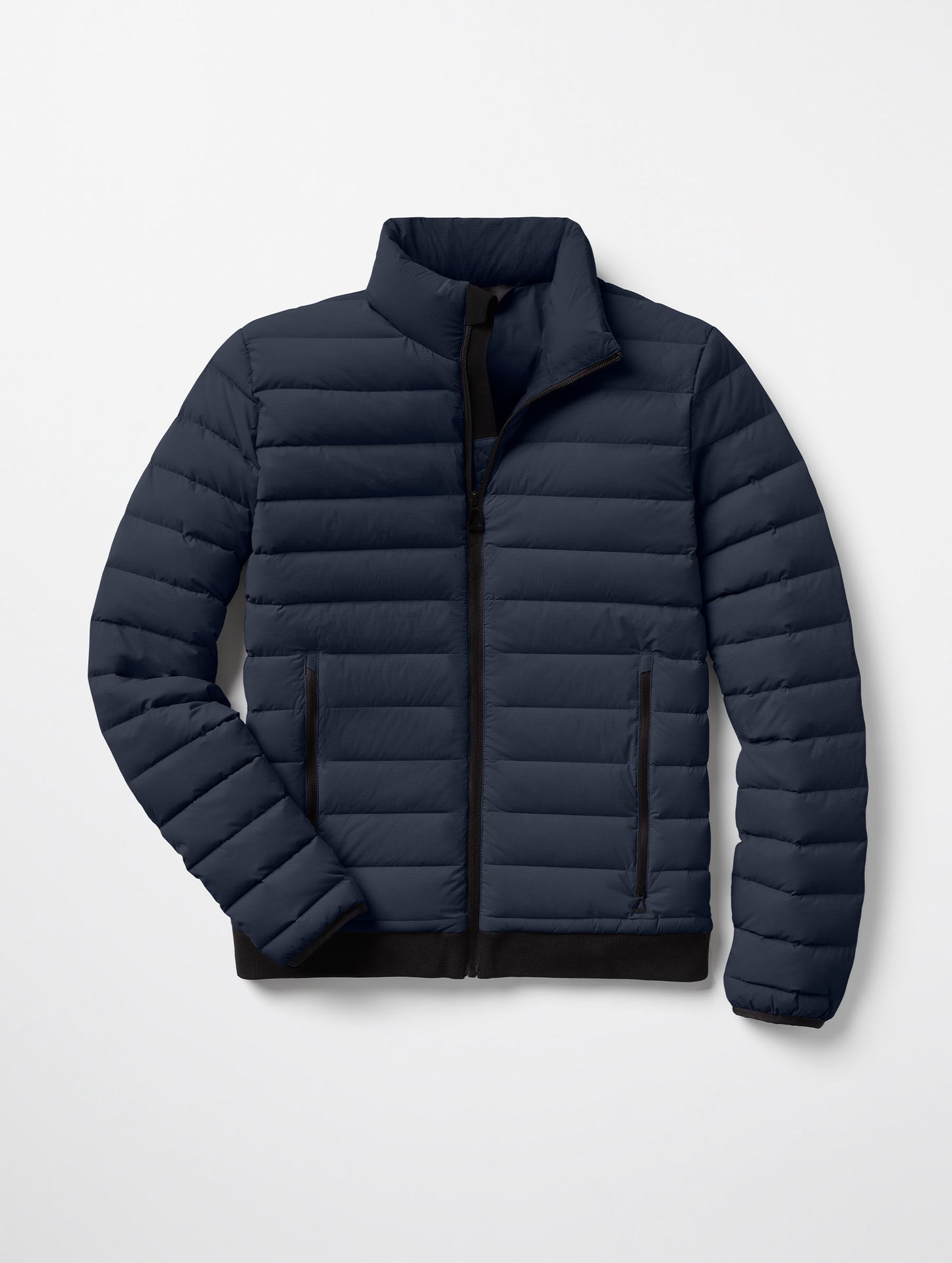 Flat lay of Launch Jacket in Total Eclipse dark blue from AETHER Apparel.