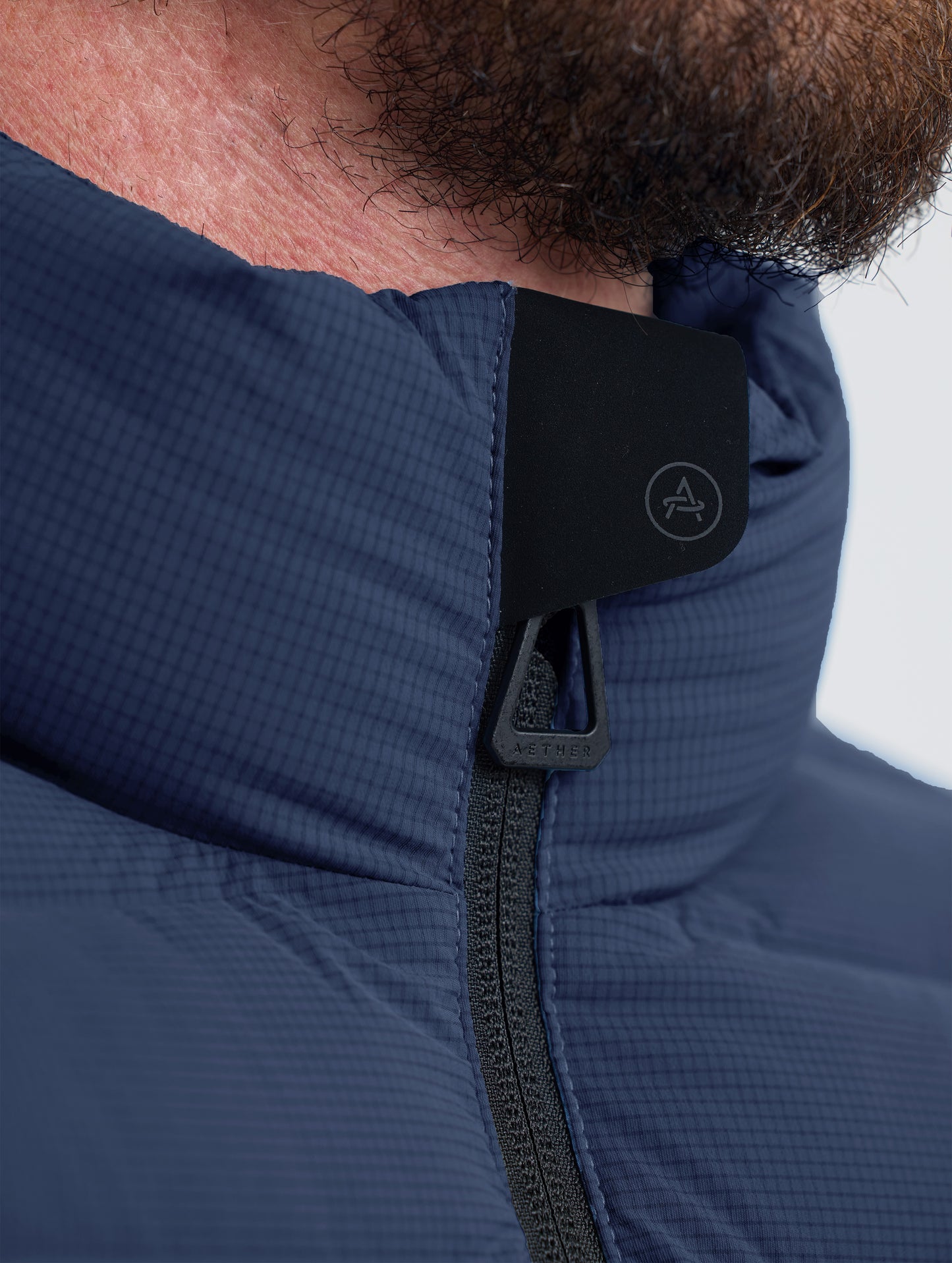 Closeup view of collar of Launch Jacket in Total Eclipse dark blue from AETHER Apparel.