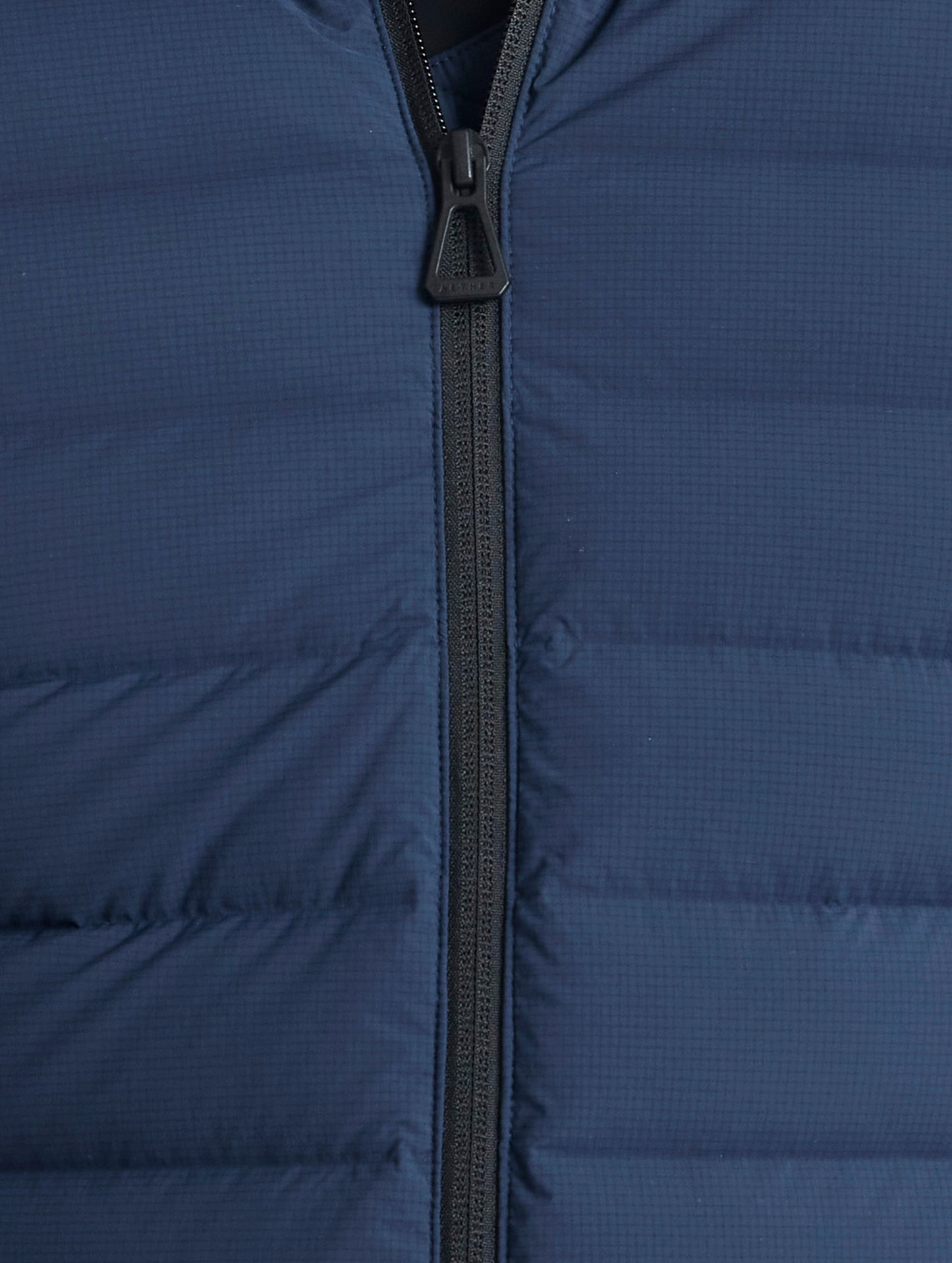 Closeup view of center zipper of Launch Jacket in Total Eclipse dark blue from AETHER Apparel.