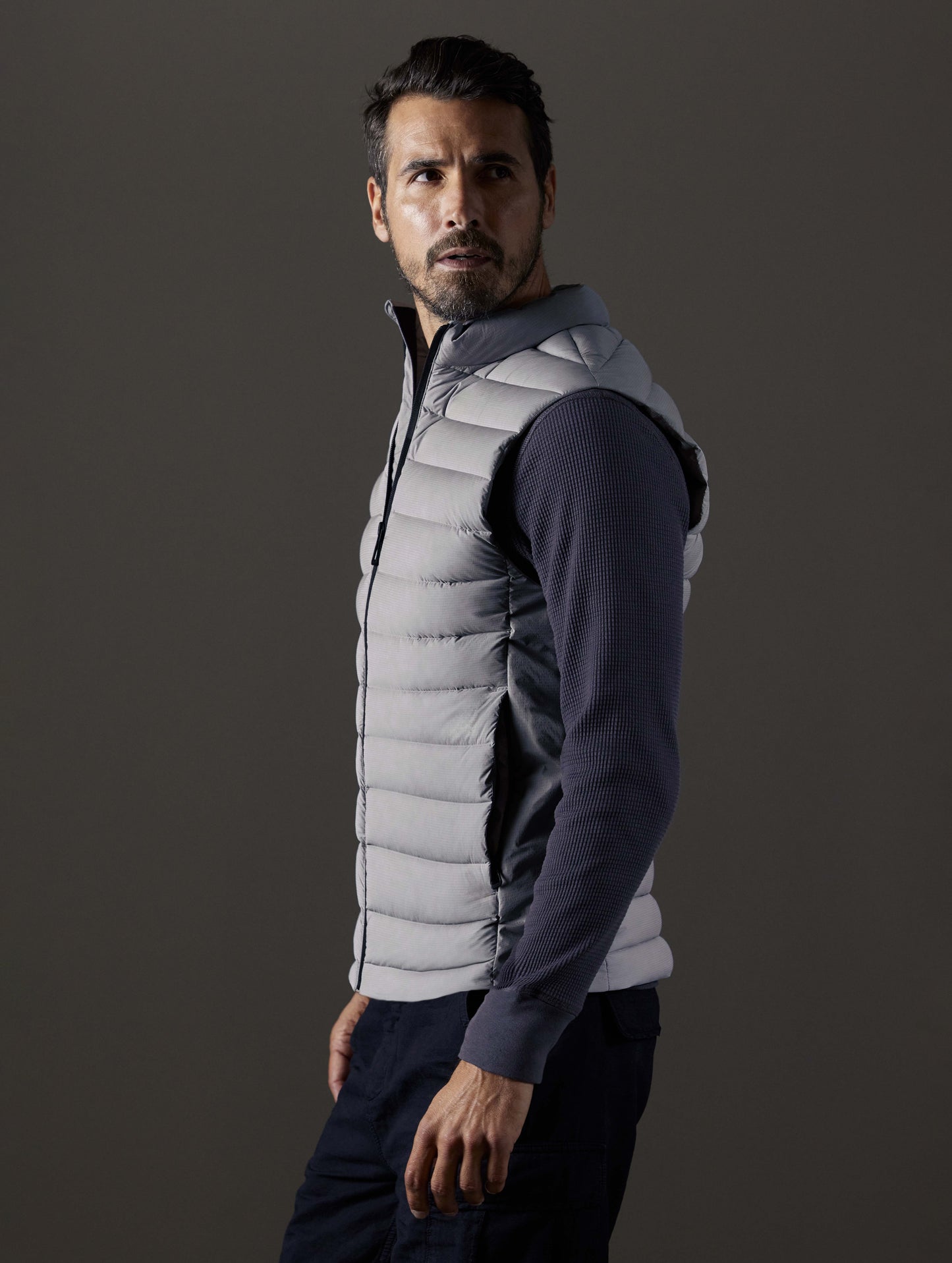 Side profile body view of man wearing Launch Vest in Sky Grey from AETHER Apparel.
