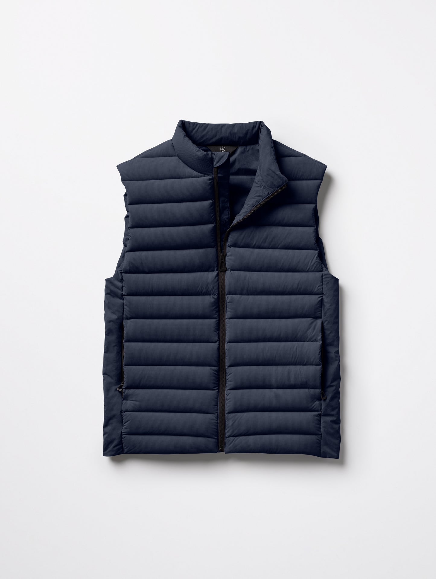 Flat lay of Launch Vest in Total Eclipse dark blue from AETHER Apparel.