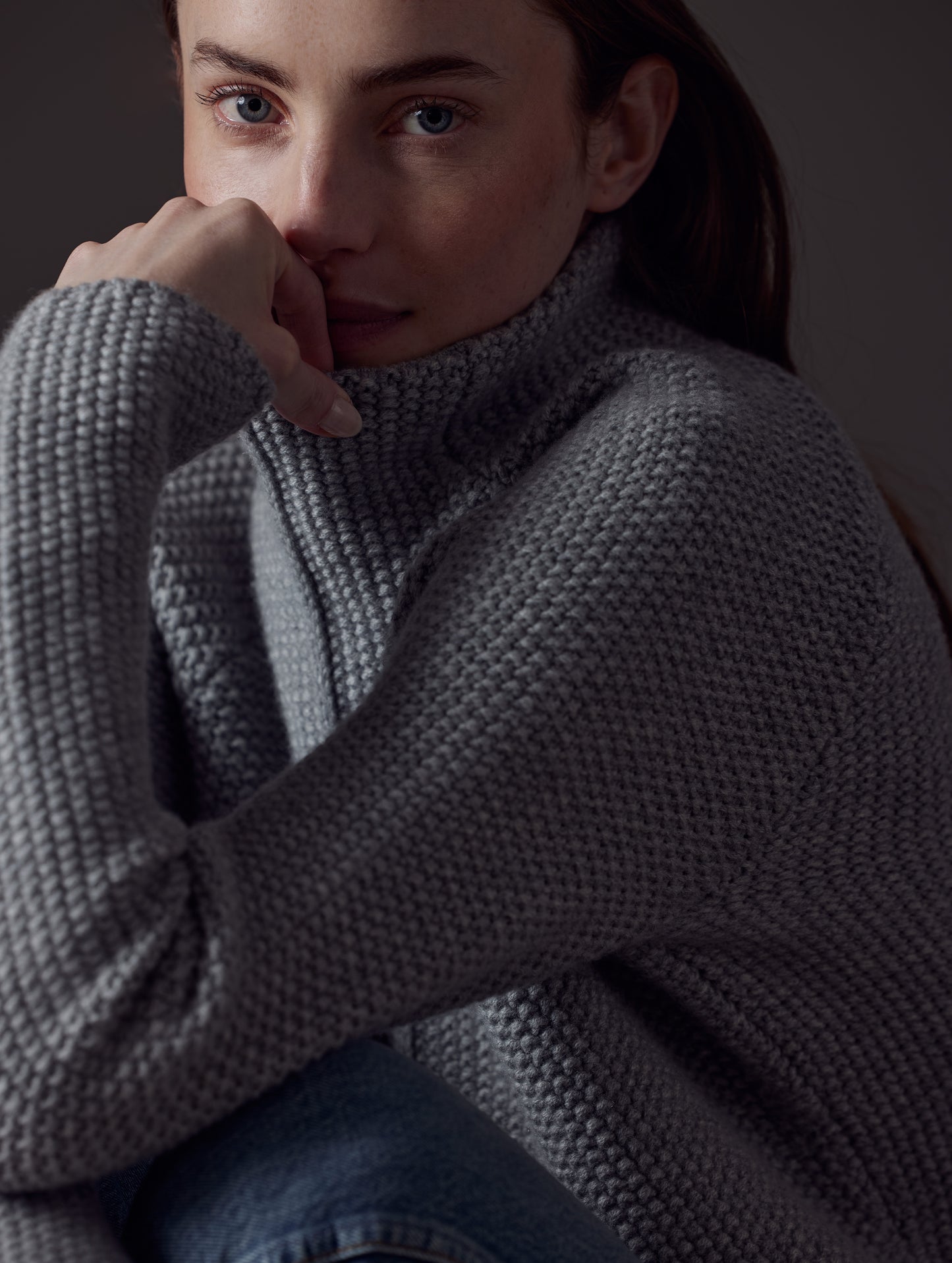 Closeup front angled view of woman wearing Luxe Seamed Sweater in Heather Grey from AETHER Apparel.