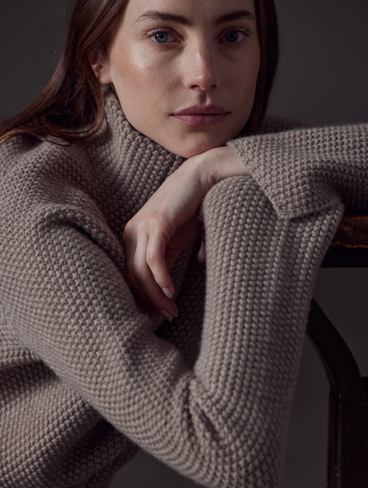 Closeup front angled view of woman wearing Luxe Seamed Sweater in Toast Brown from AETHER Apparel.