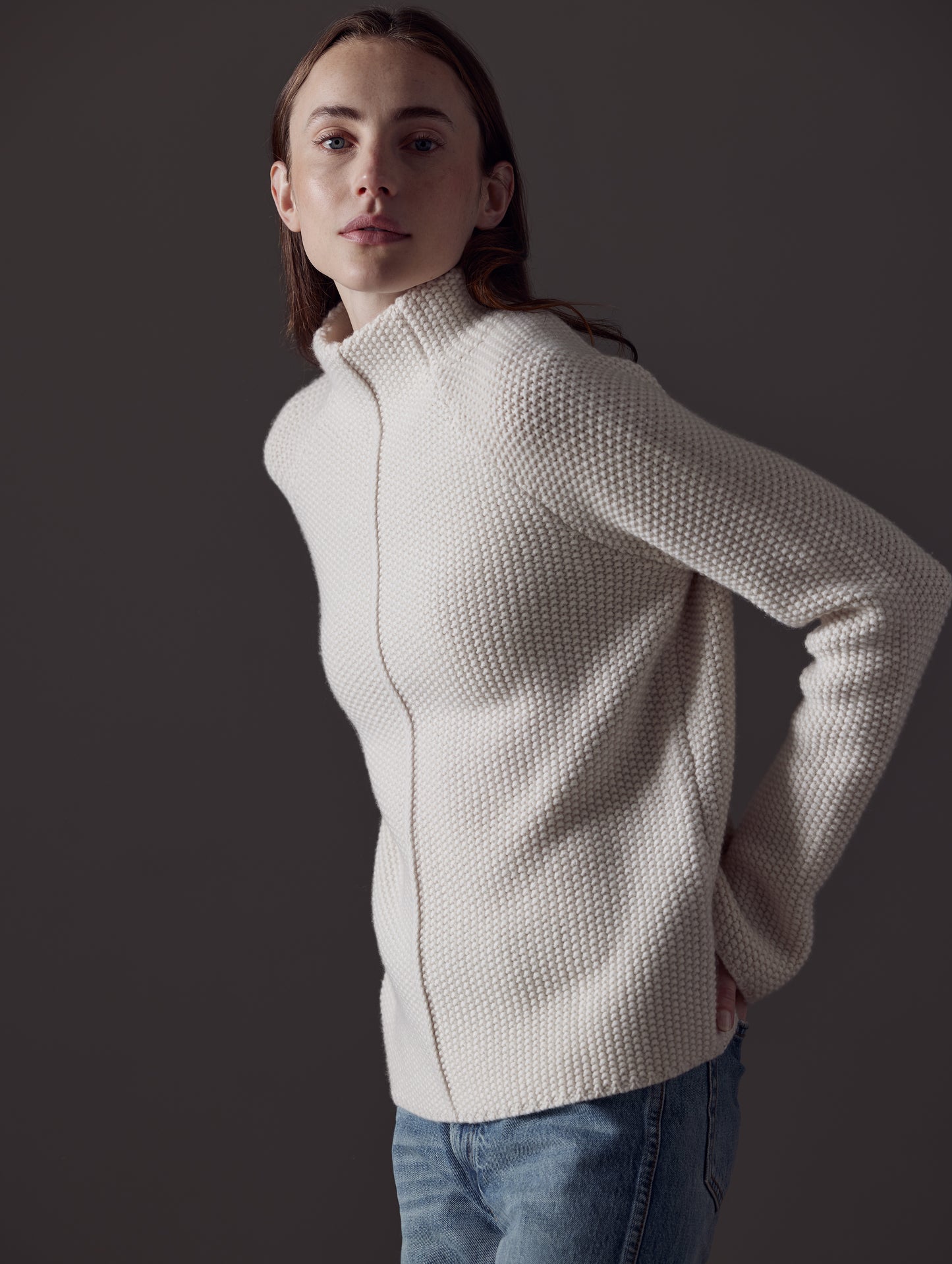 Front angled view of woman wearing Luxe Seamed Sweater in Winter White from AETHER Apparel.