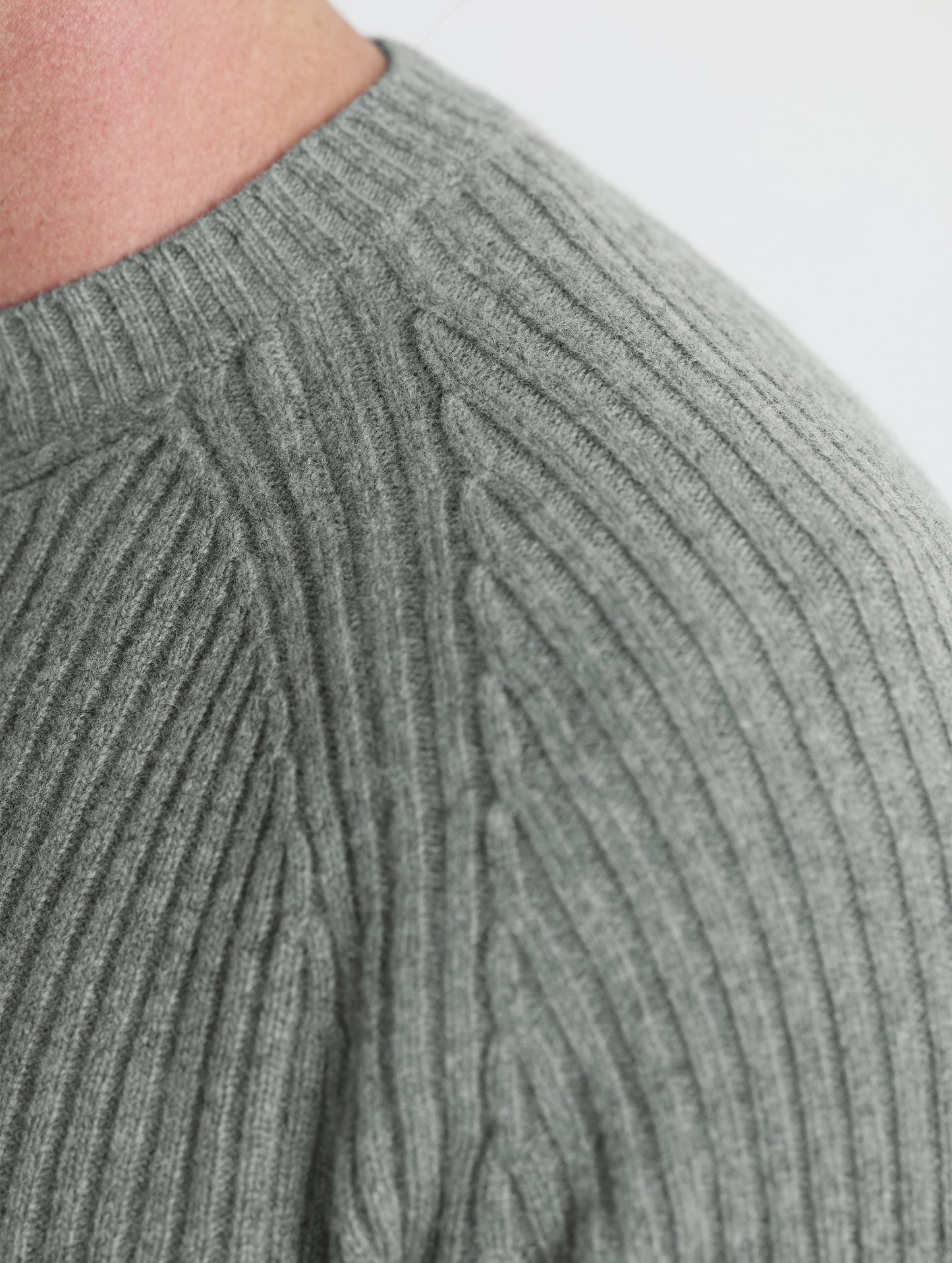 Closeup detail view of wearer's left shoulder of Lyon Sweater in Gunmetal grey from AETHER Apparel.