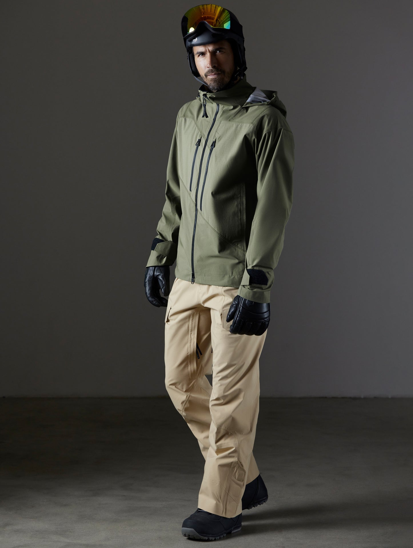 Front 3/4 full-body view of man wearing Maverick Snow-Shell Jacket in Fern Green and Maverick Sow-Shell Pant in Desert Tan from AETHER Apparel.